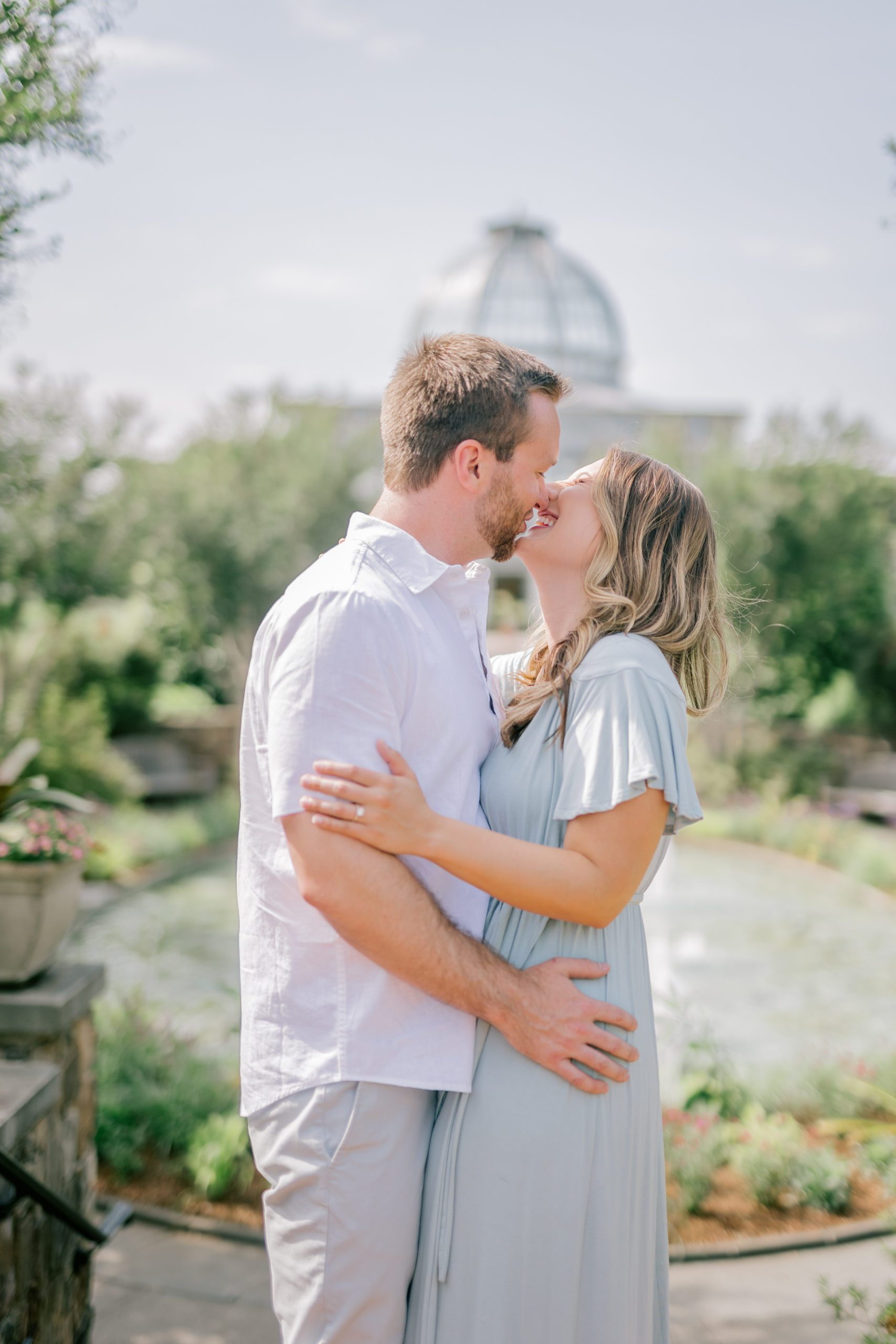 Couple laughing and kissing - Lewis Ginter Botanical Garden Engagement Session - Garden Engagement Session