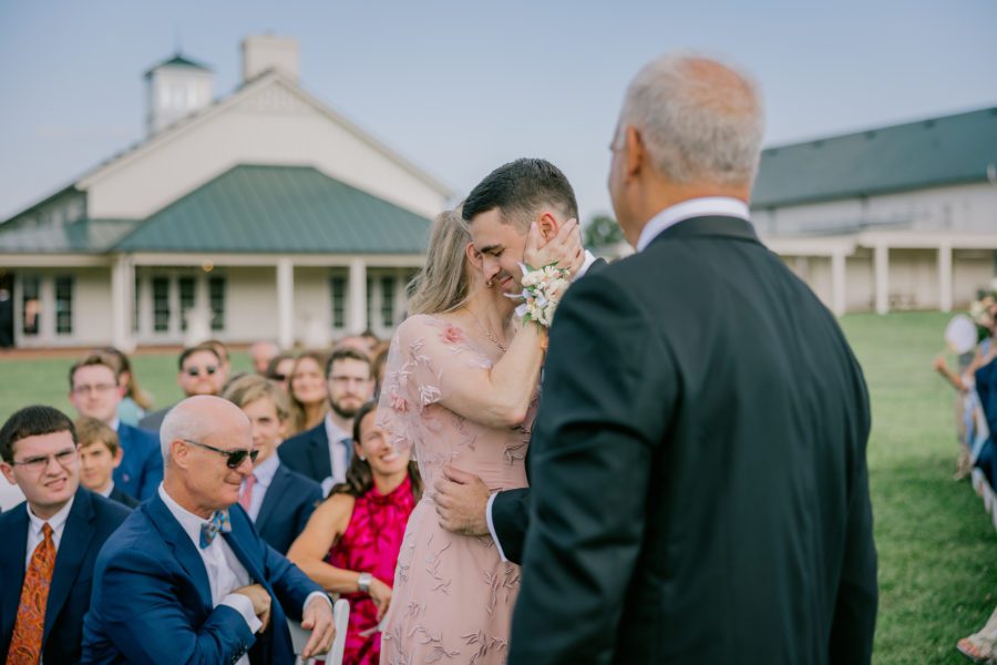 groom embraces his mom at their King Family Vineyard wedding ceremony