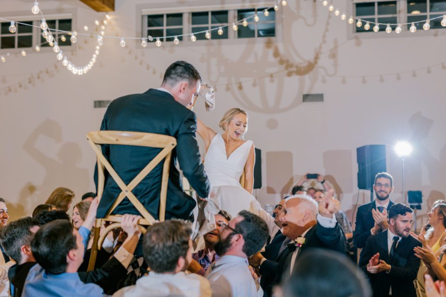 The bride and groom during the traditional Hora Jewish dance.