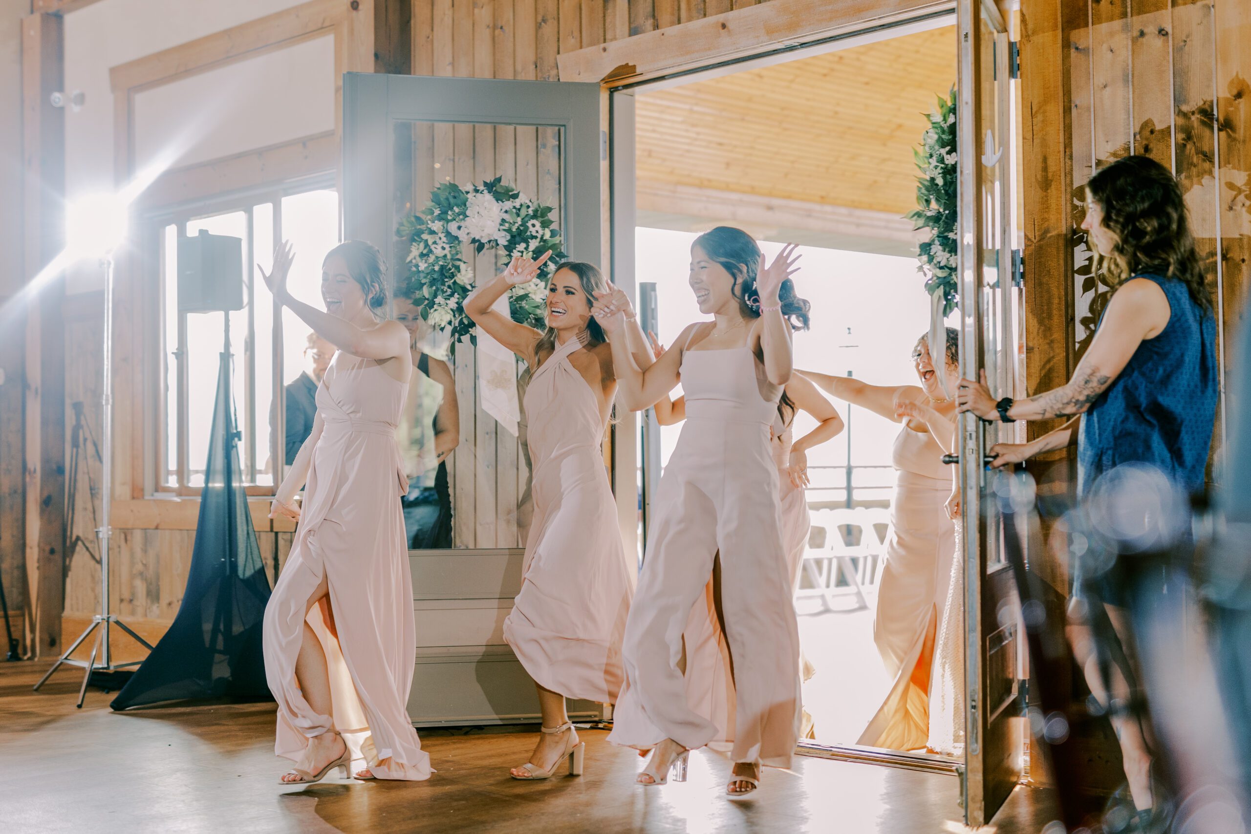 Bridesmaids enter reception dancing and cheering at irvine estate