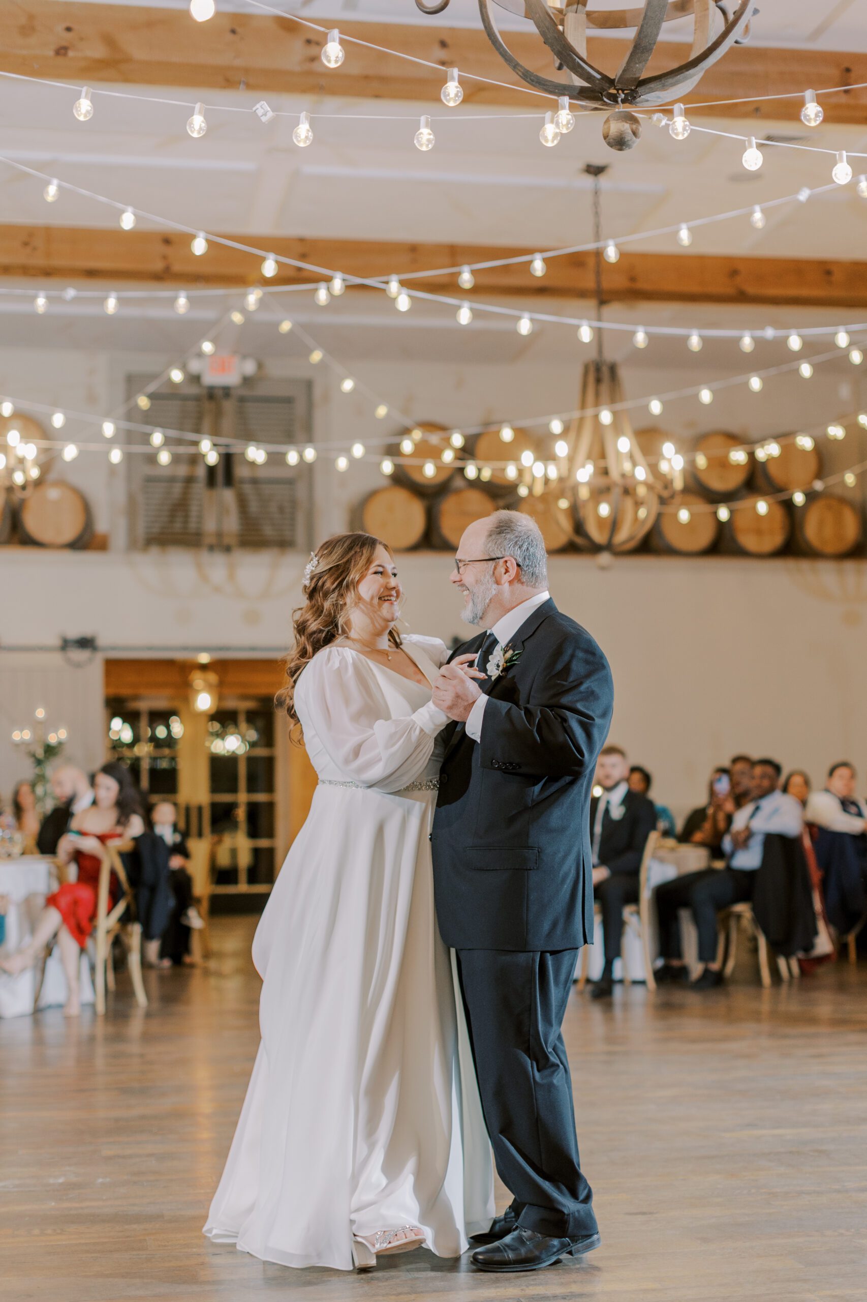 Father daughter dance with bride and her dad on the dance floor, beautiful string twinkle light hangs above them
