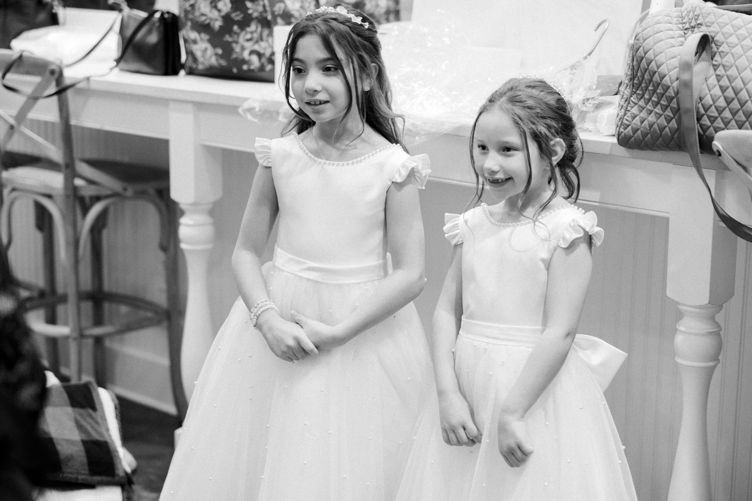 Black and white image of two young girls dressed in formal dresses at king family vineyards