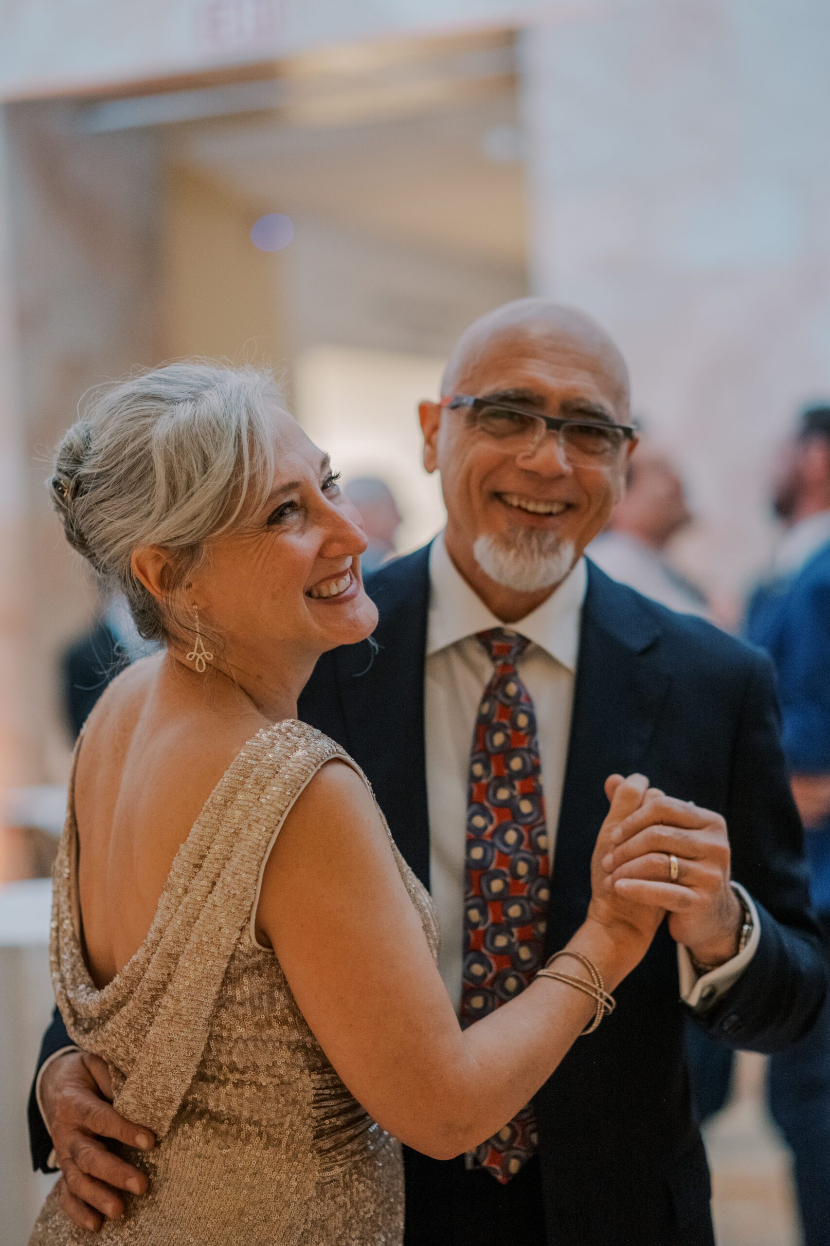 Close up image of a couple dancing and smiling at the vmfa fall wedding