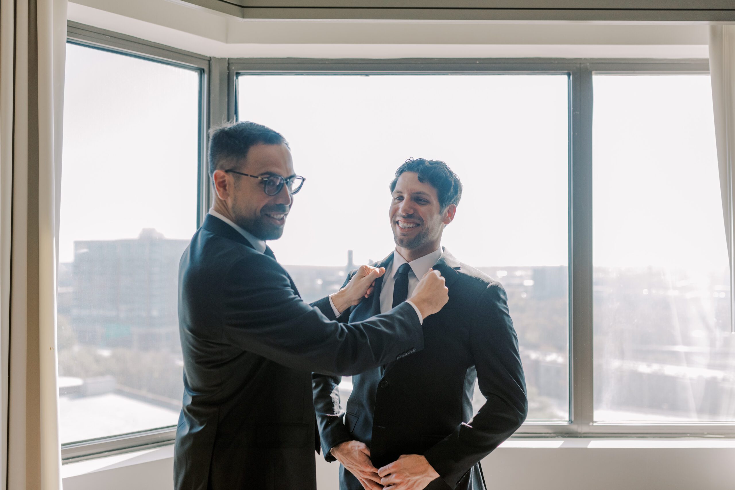 A friend helping the groom get ready for his vmfa fall wedding