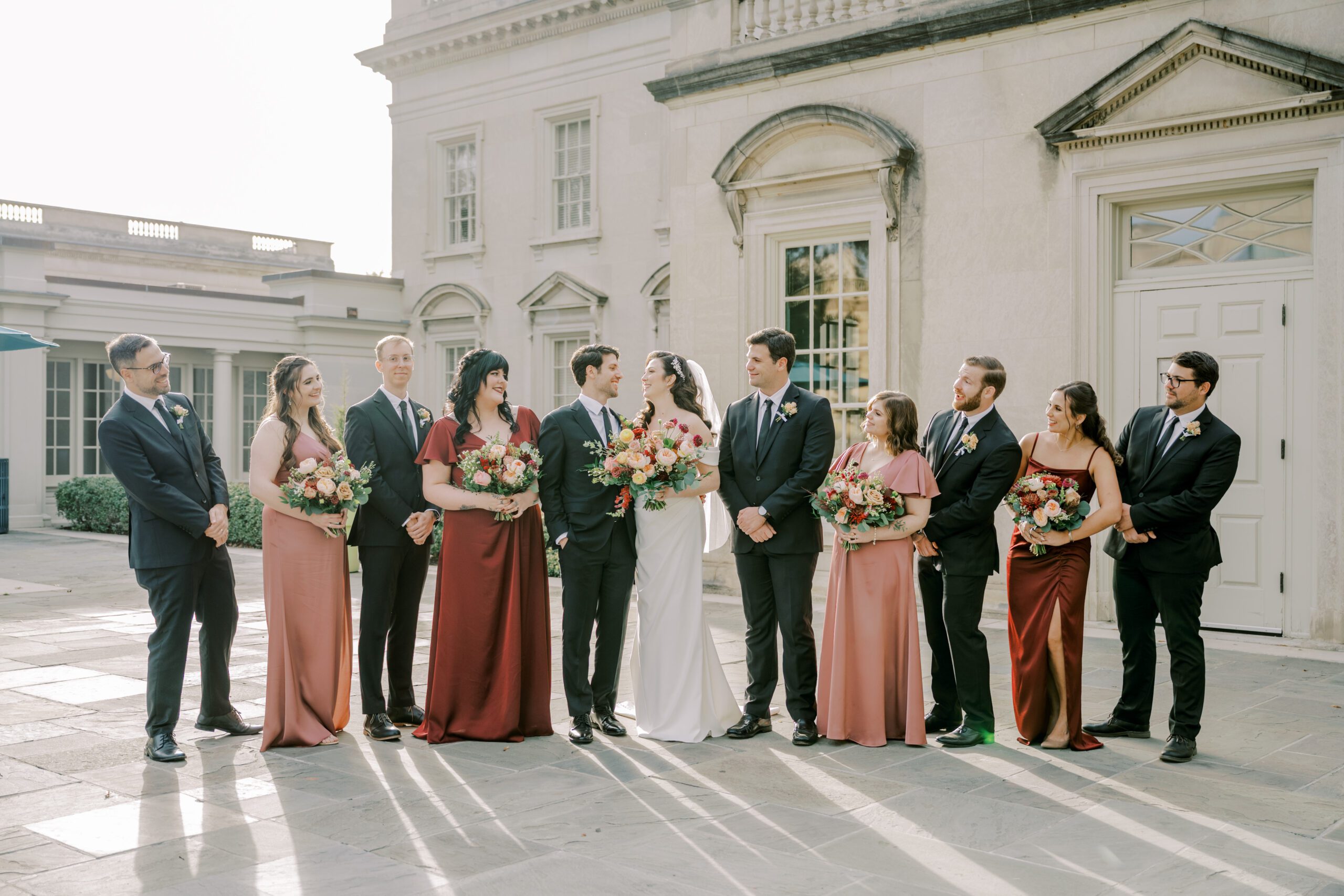 Entire wedding party alternating male and female, with bride and groom in center of line