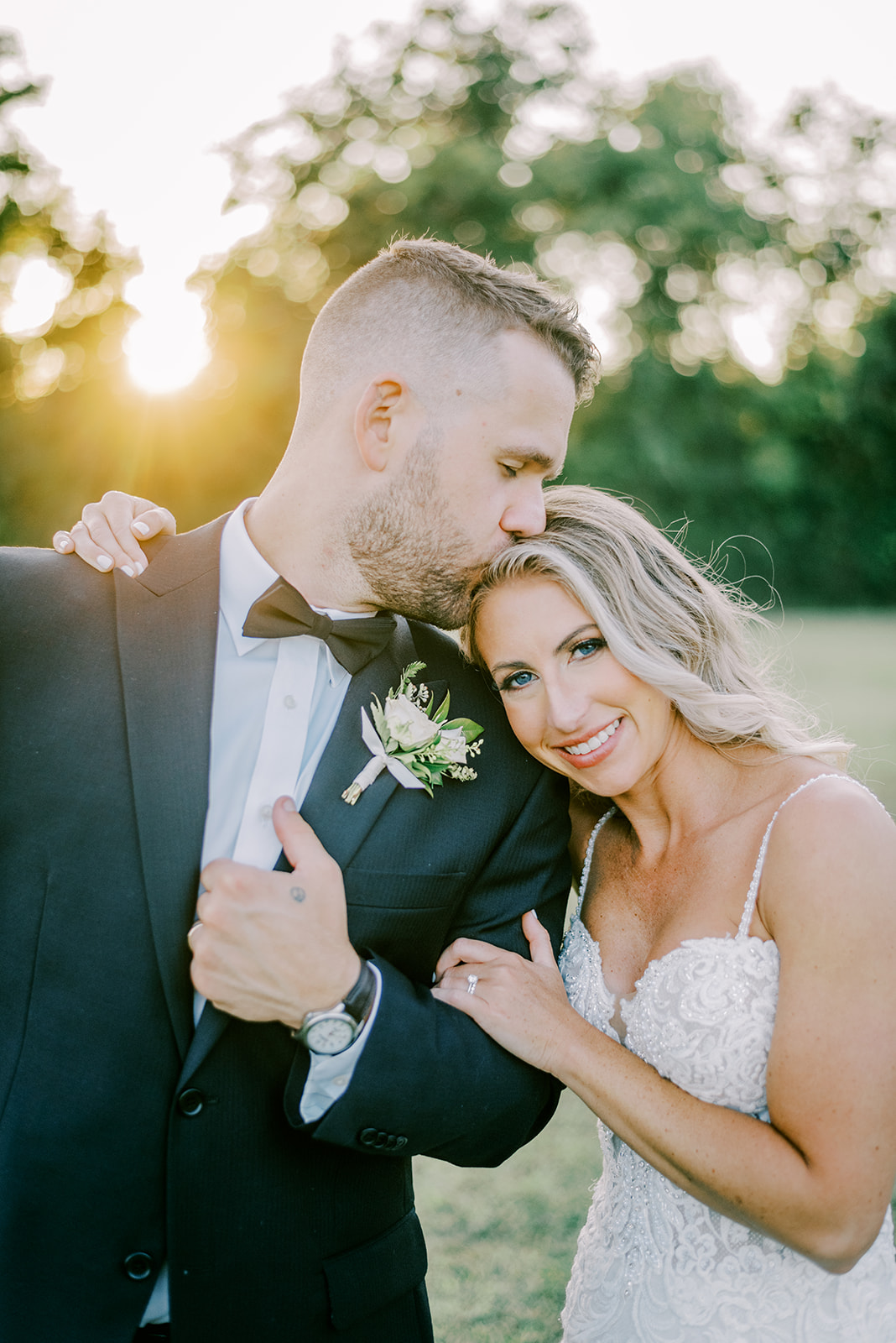 A Waverly Estate wedding bride and groom smile at the camera during their golden hour portraits.