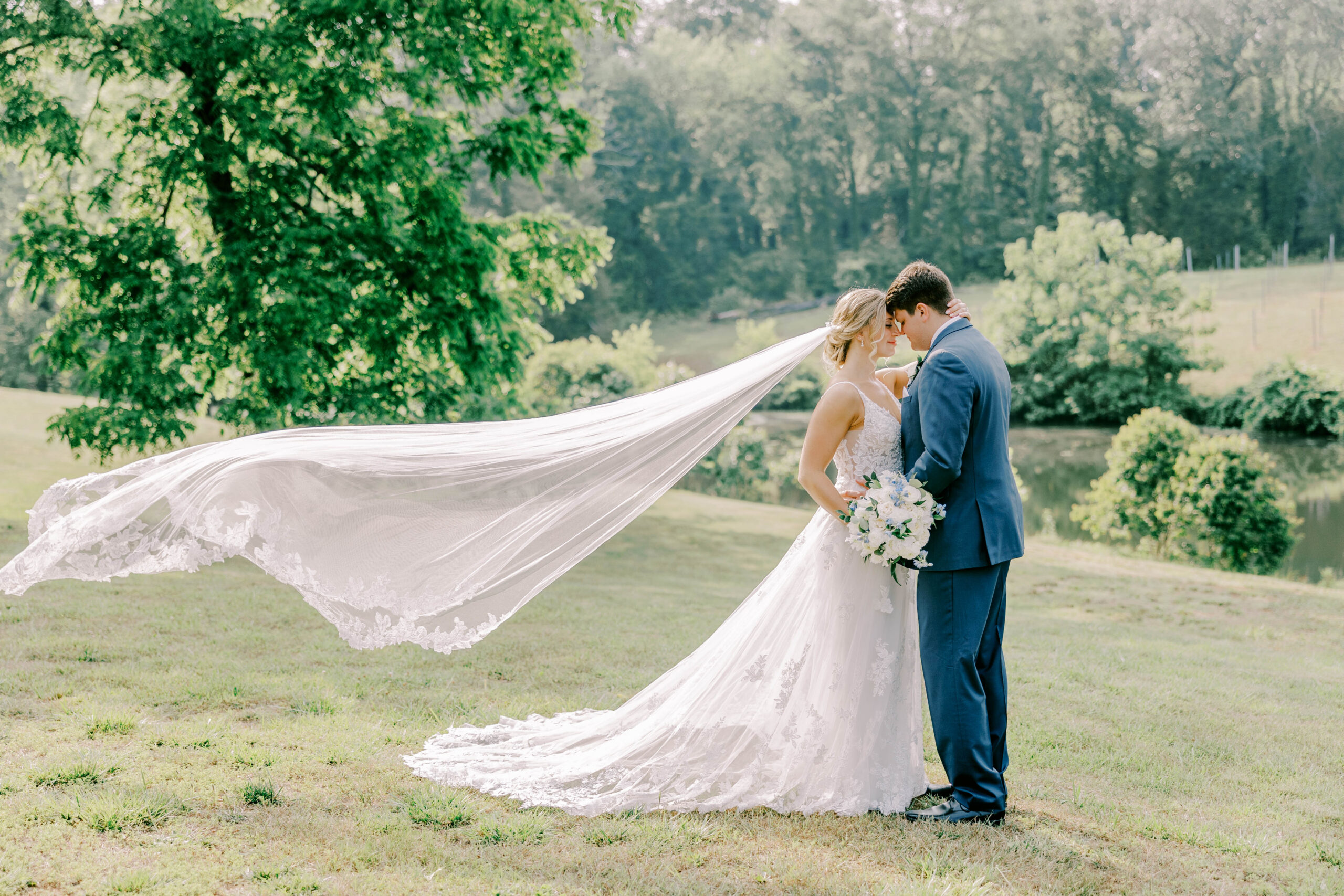 Poplar Springs Manor bride and groom with a veil blowing behind the bride