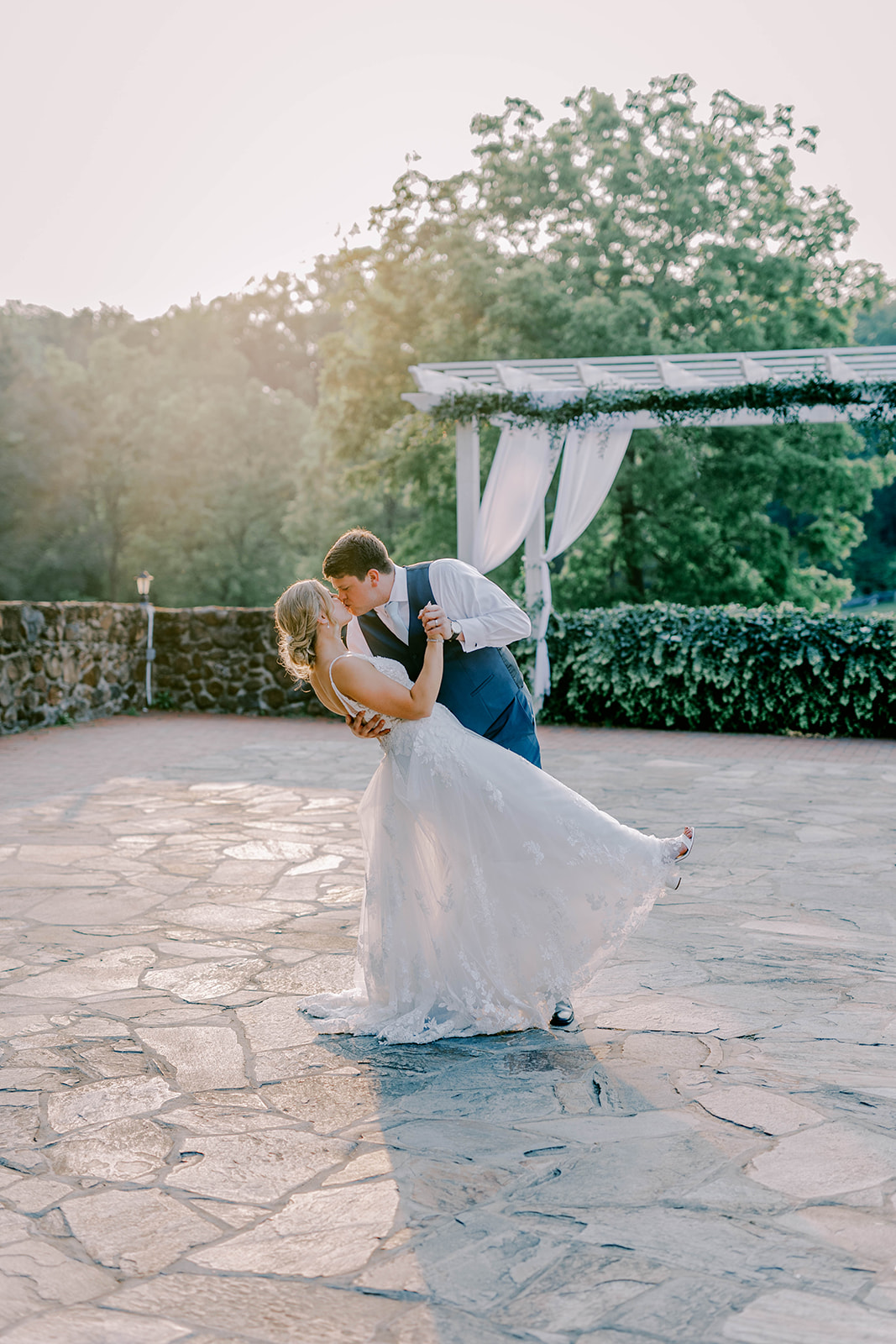 A bride and groom pose for a romantic golden hour wedding photo at Poplar Springs Manor.