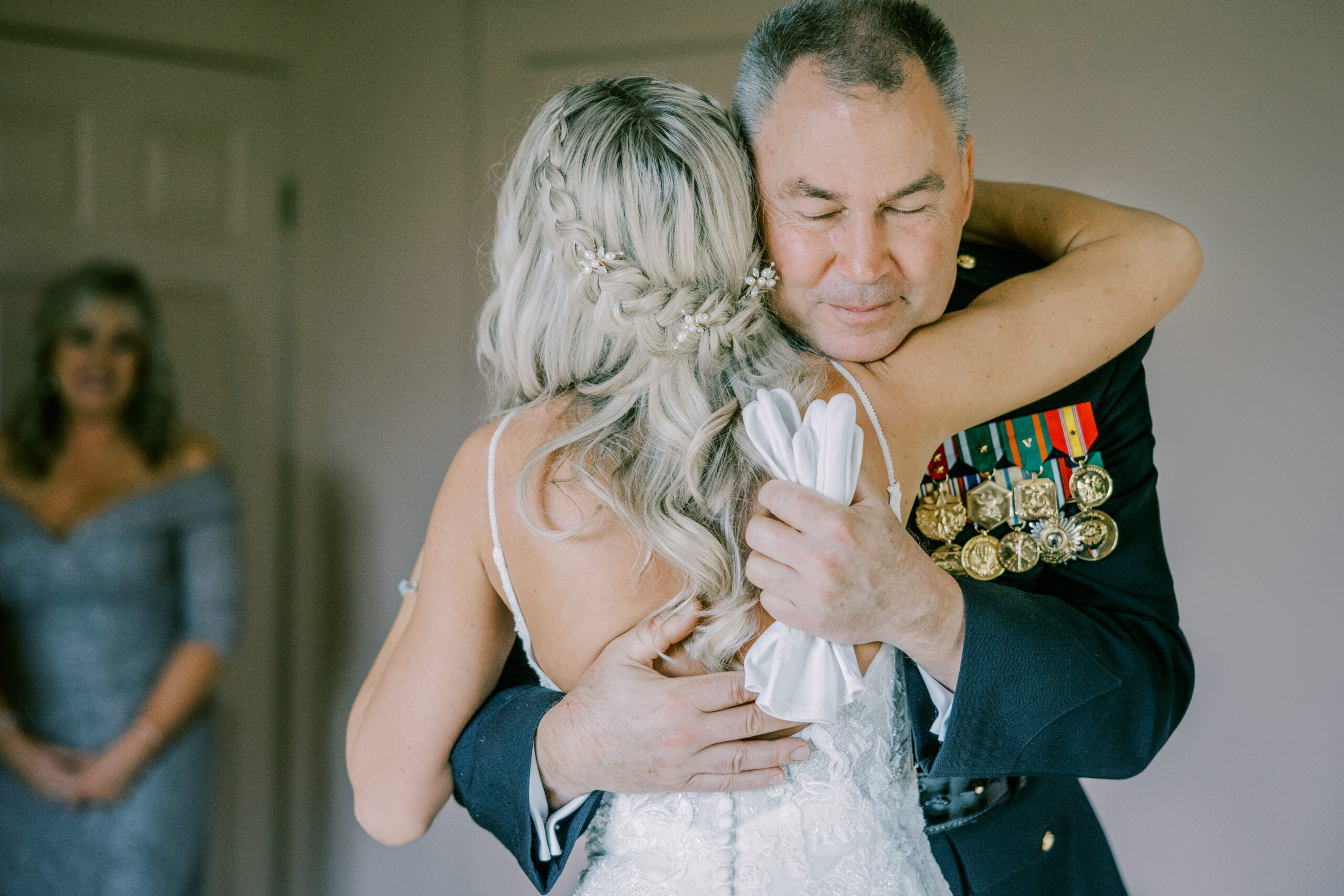 the bride embraces her dad during her big spring farm wedding photos