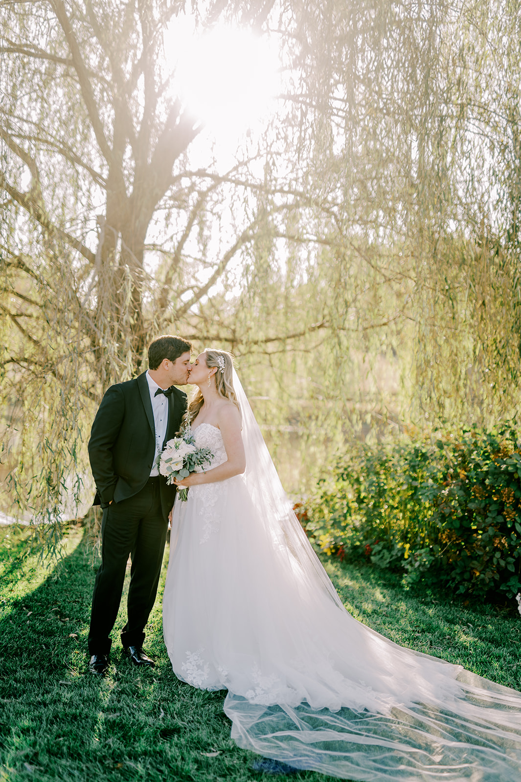 A Mount Ida Farm sunset portrait of the bride and groom kissing.