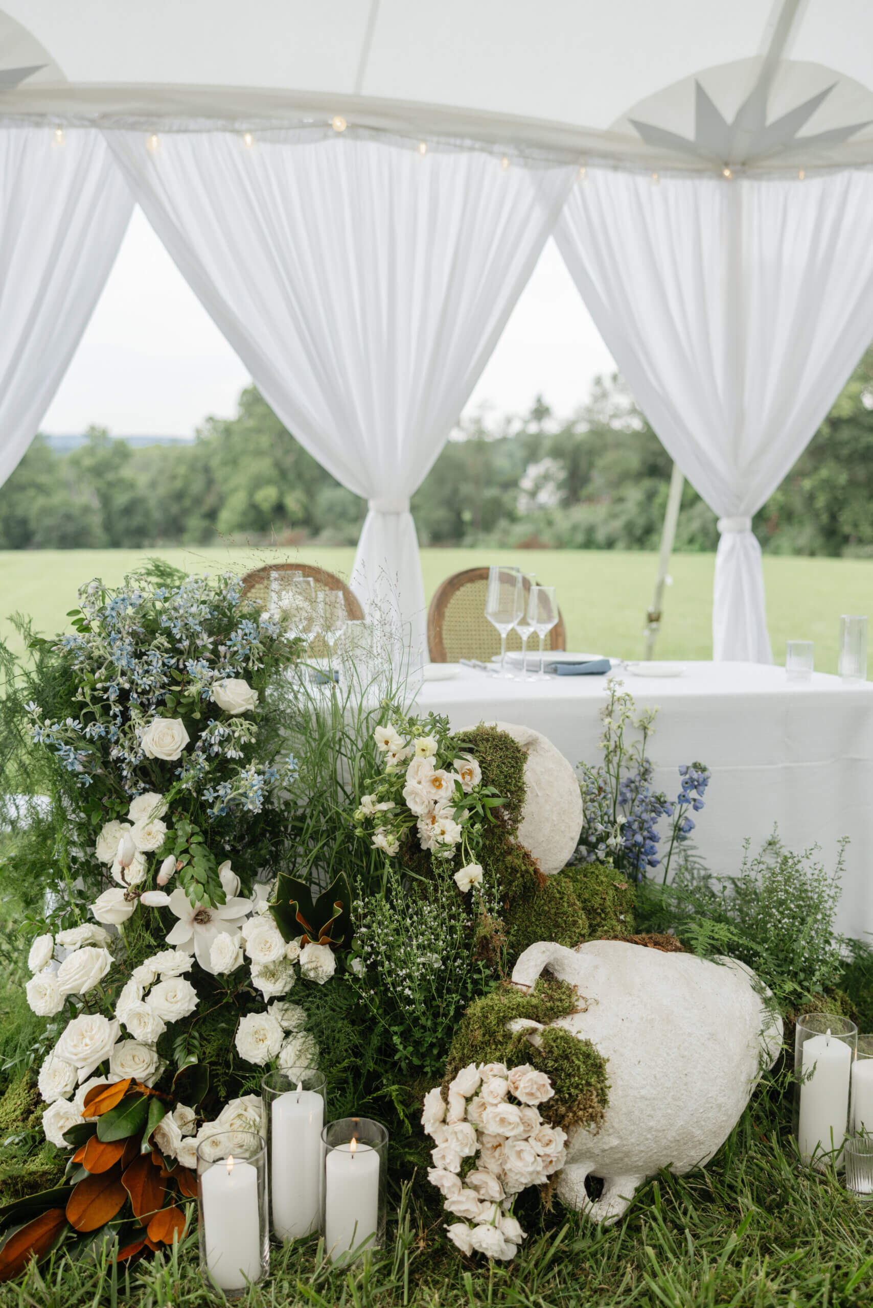 Private Residence Summer Wedding 4 Sweetheart table set up with large greenery and floral arrangement in front of it