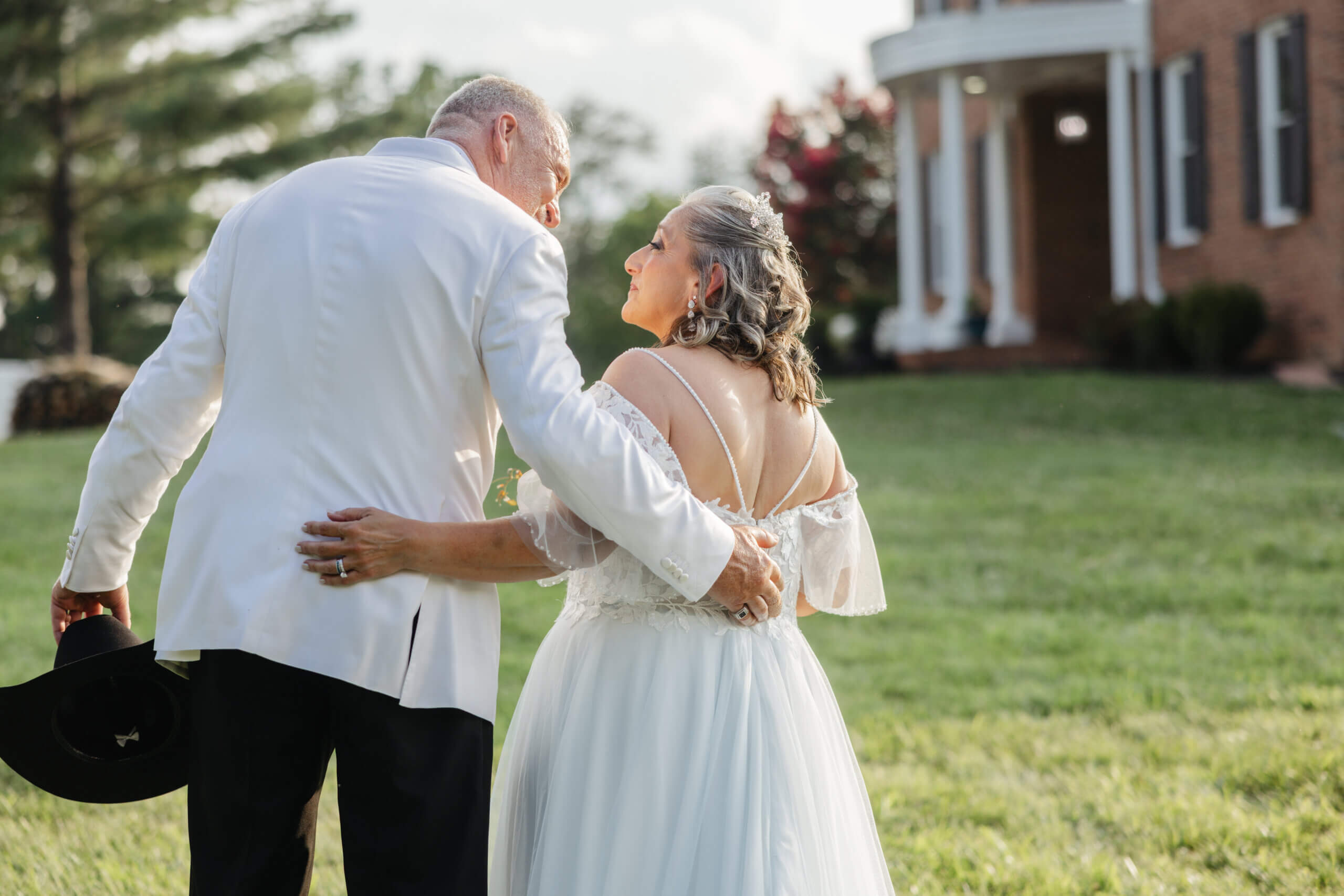 Private Residence Summer Wedding 23 Bride and groom leaning in for a kiss right after their wedding ceremony