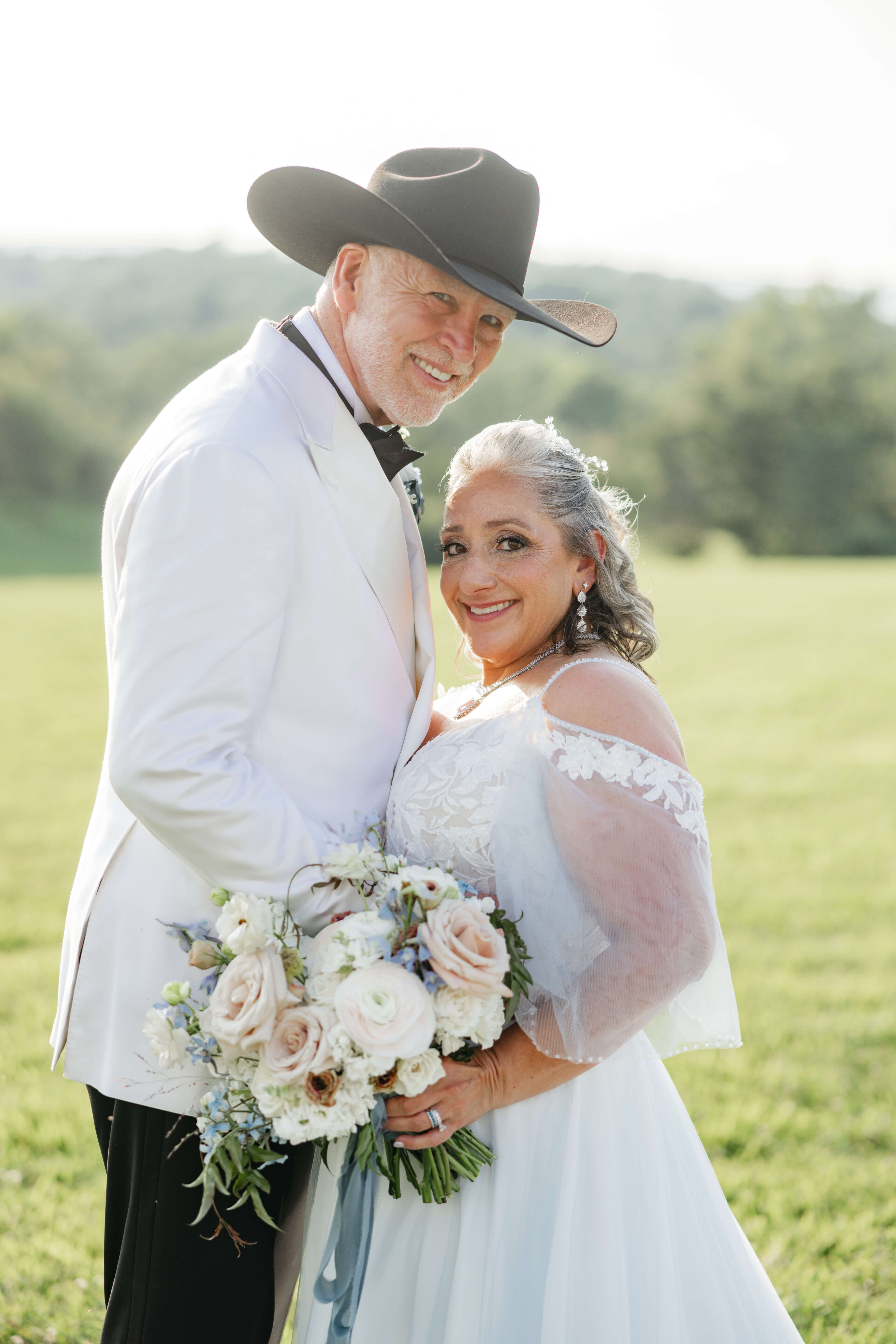 Private Residence Summer Wedding 25 Bride and groom lean in, both smiling at camera