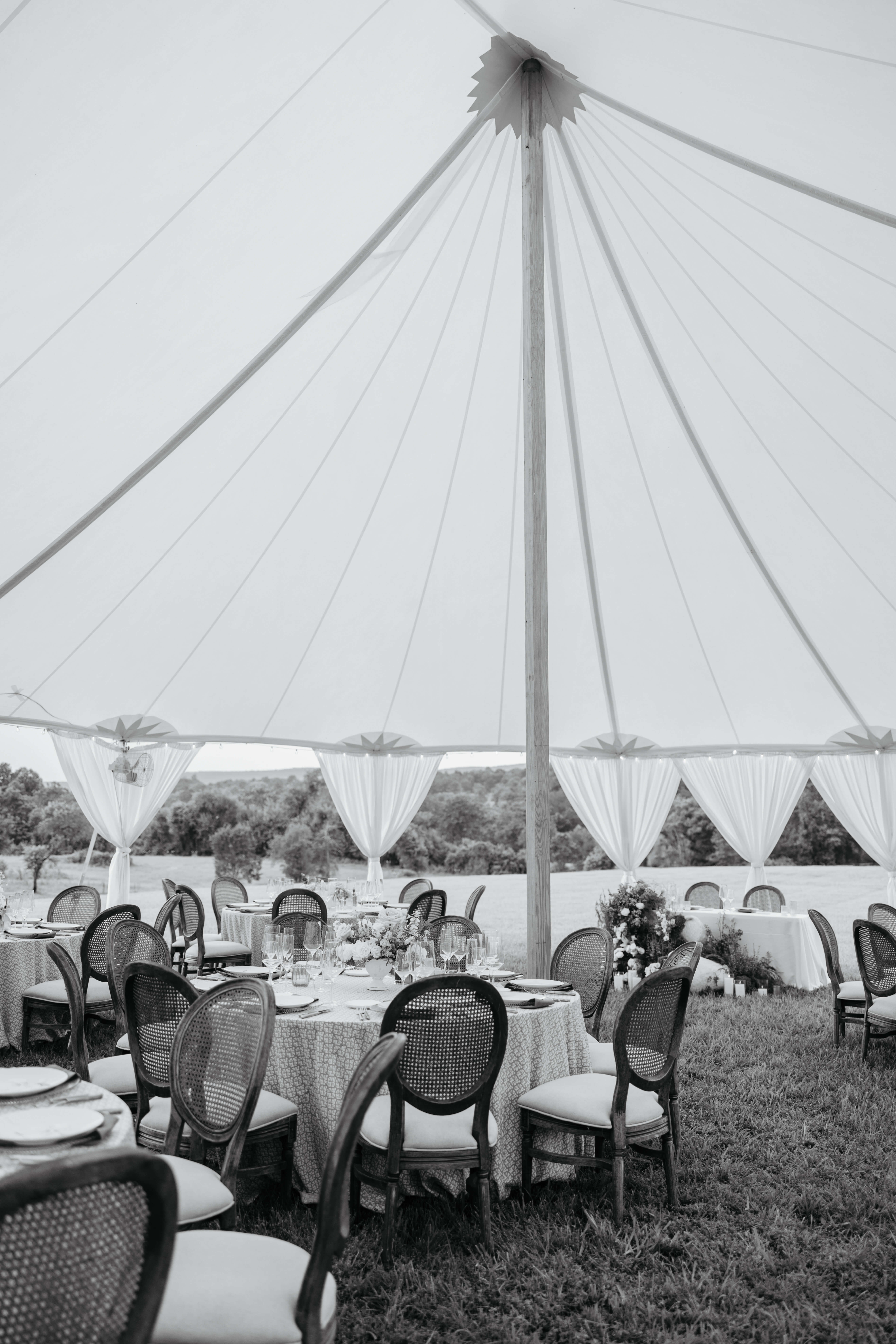 Private Residence Summer Wedding 6 Black and white photo of tent set up outside with tables underneath