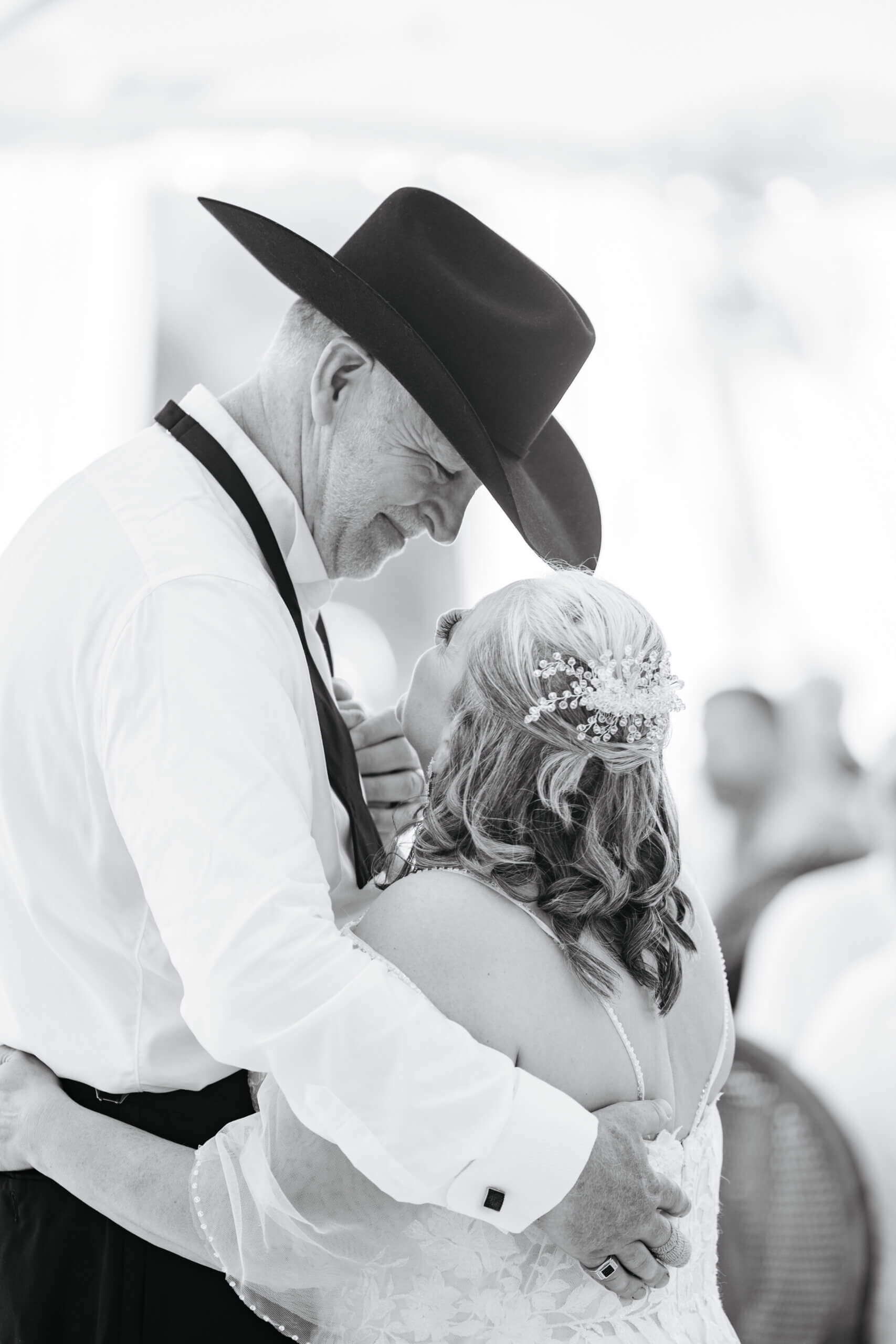 Private Residence Summer Wedding 31 Black and white photo of bride looking up at groom and groom looking down at bride smiling as they dance their first dance