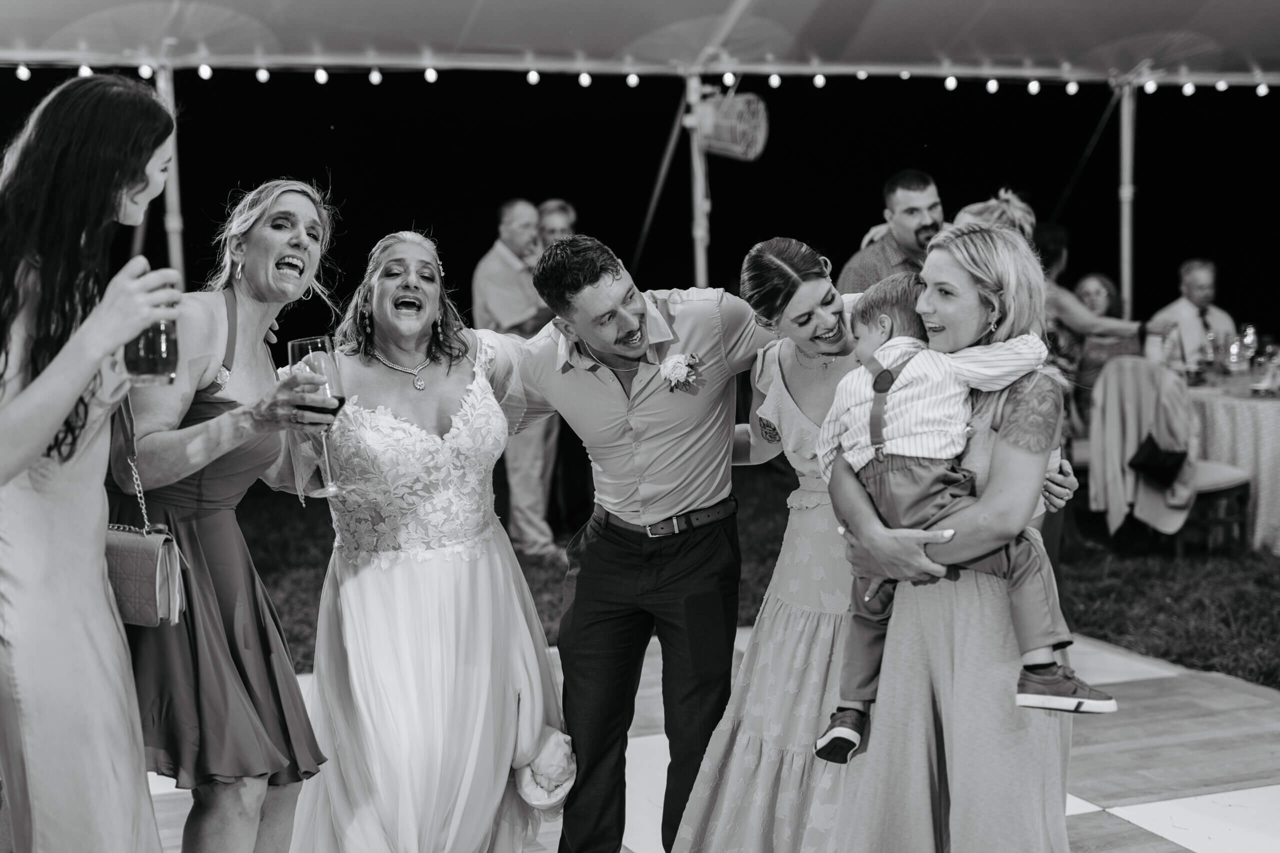 Private Residence Summer Wedding 44 Black and white photo of bride and guests dancing on the dance floor