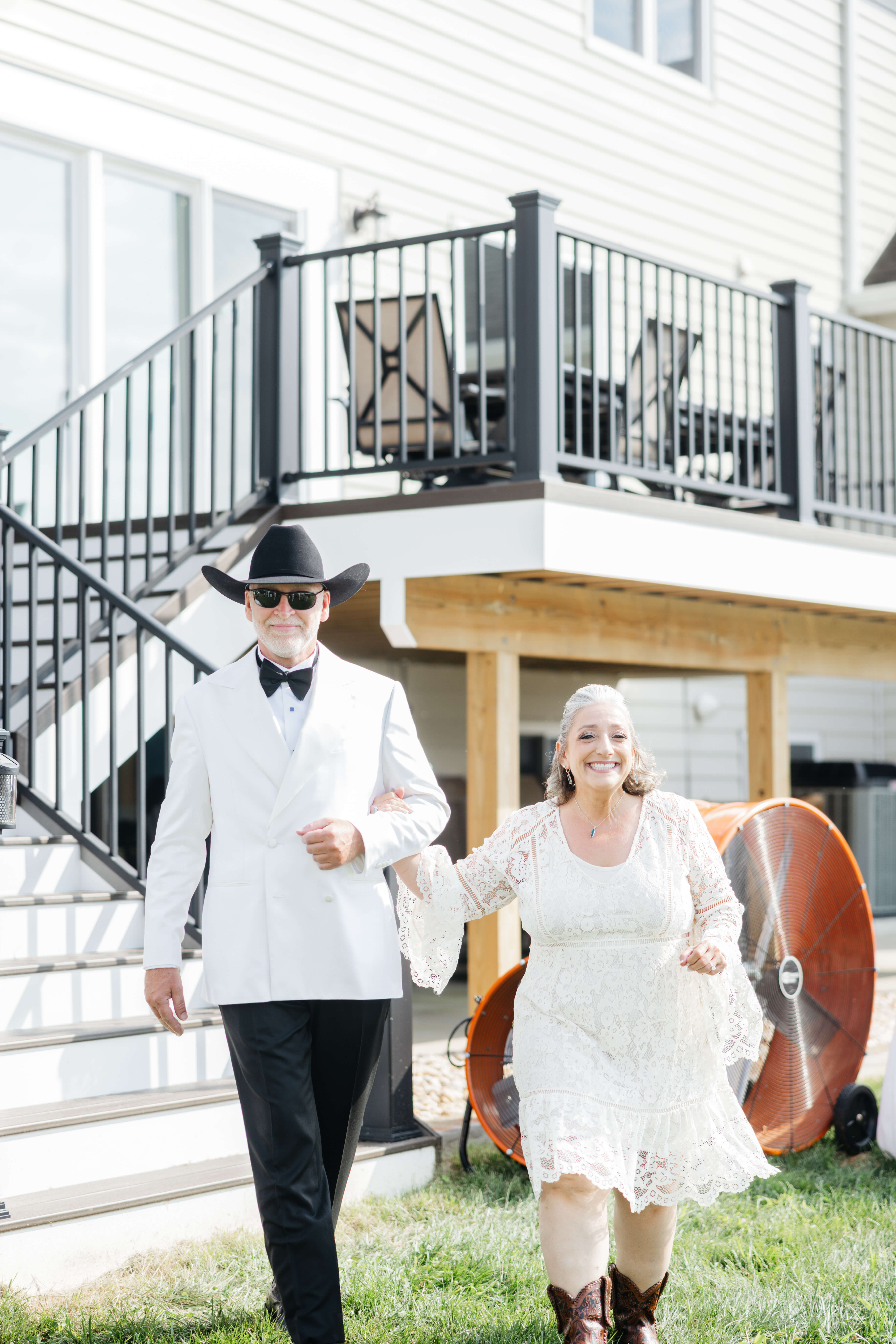Private Residence Summer Wedding 8 Bride and groom walking out of their home to join the party pre ceremony