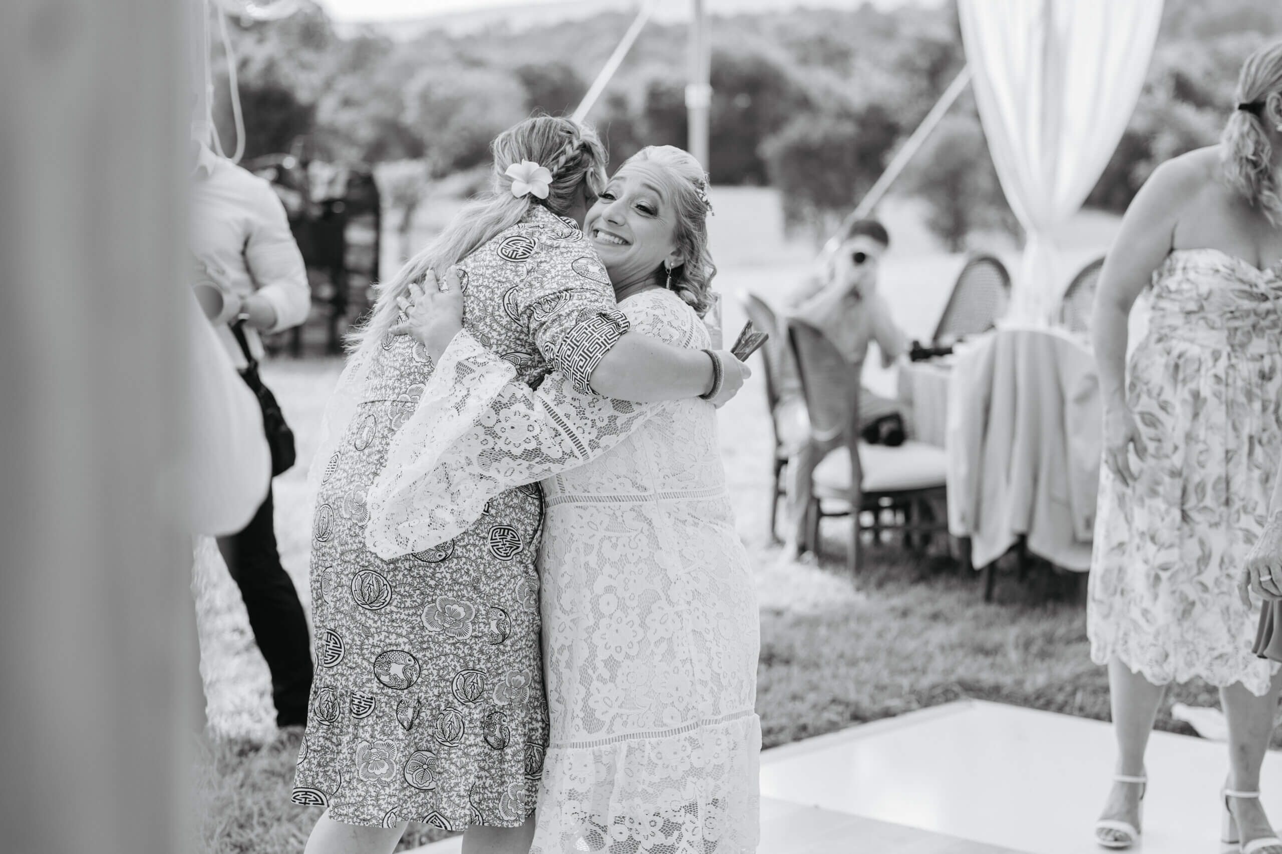 Private Residence Summer Wedding 9 Bride hugging friends to welcome them to the wedding