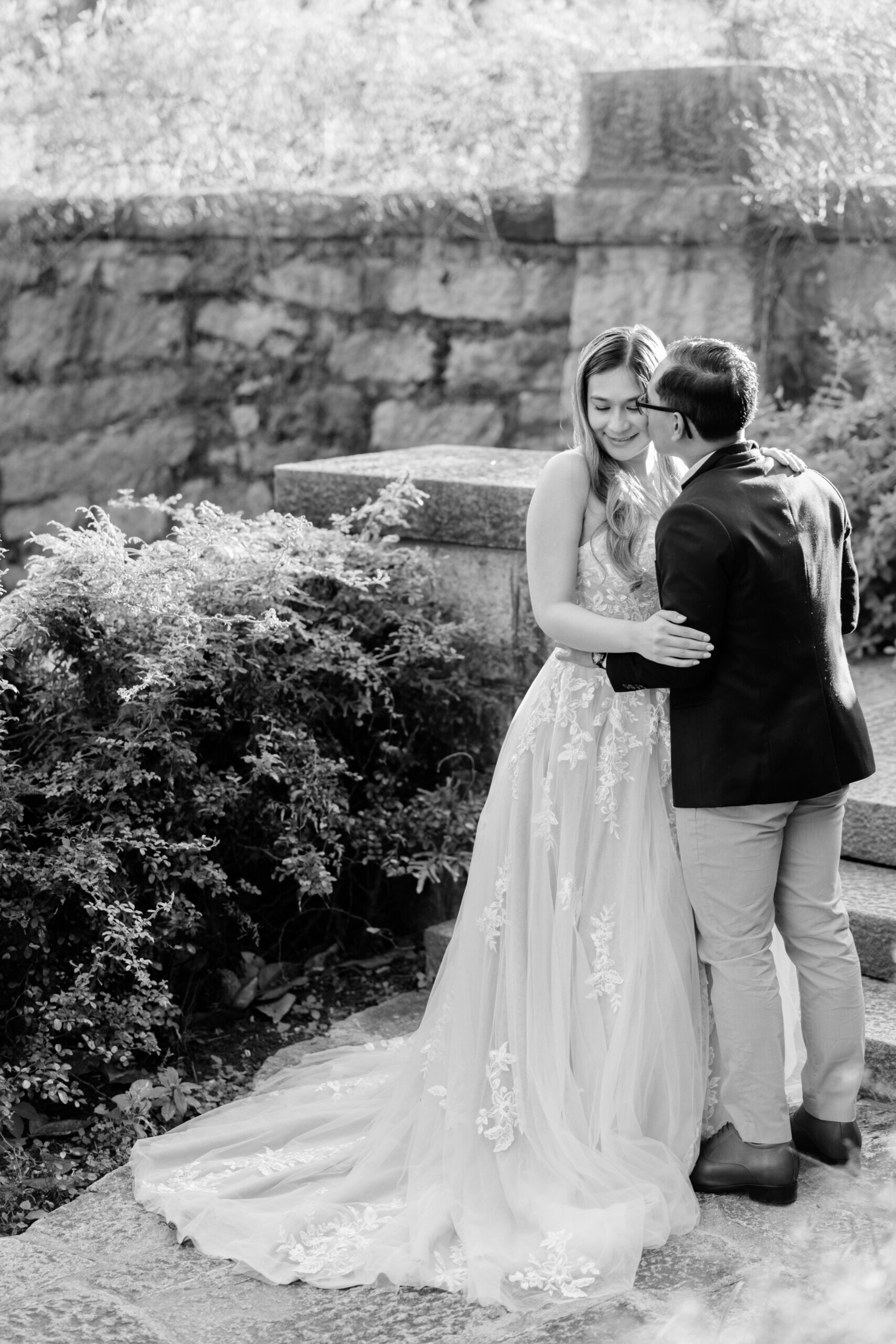 Maymont Park Engagement Summer Photography 1 Black and white photo of engaged couple, woman in beautiful wedding like dress as man kisses her cheek