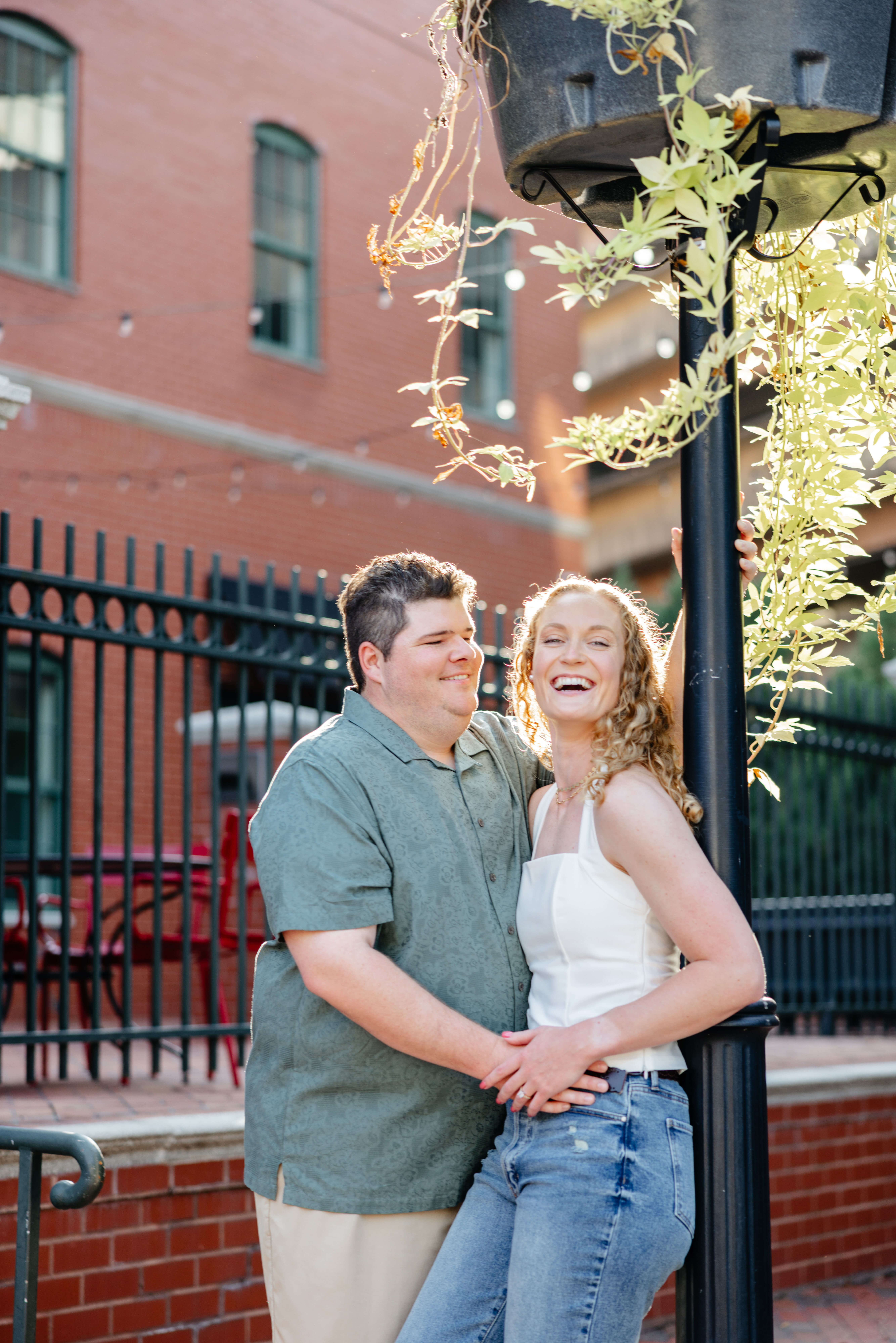 Shockhoe Bottom Fall Engagement Photography 5 Woman leaning against lamp post as her fiance puts his hand
