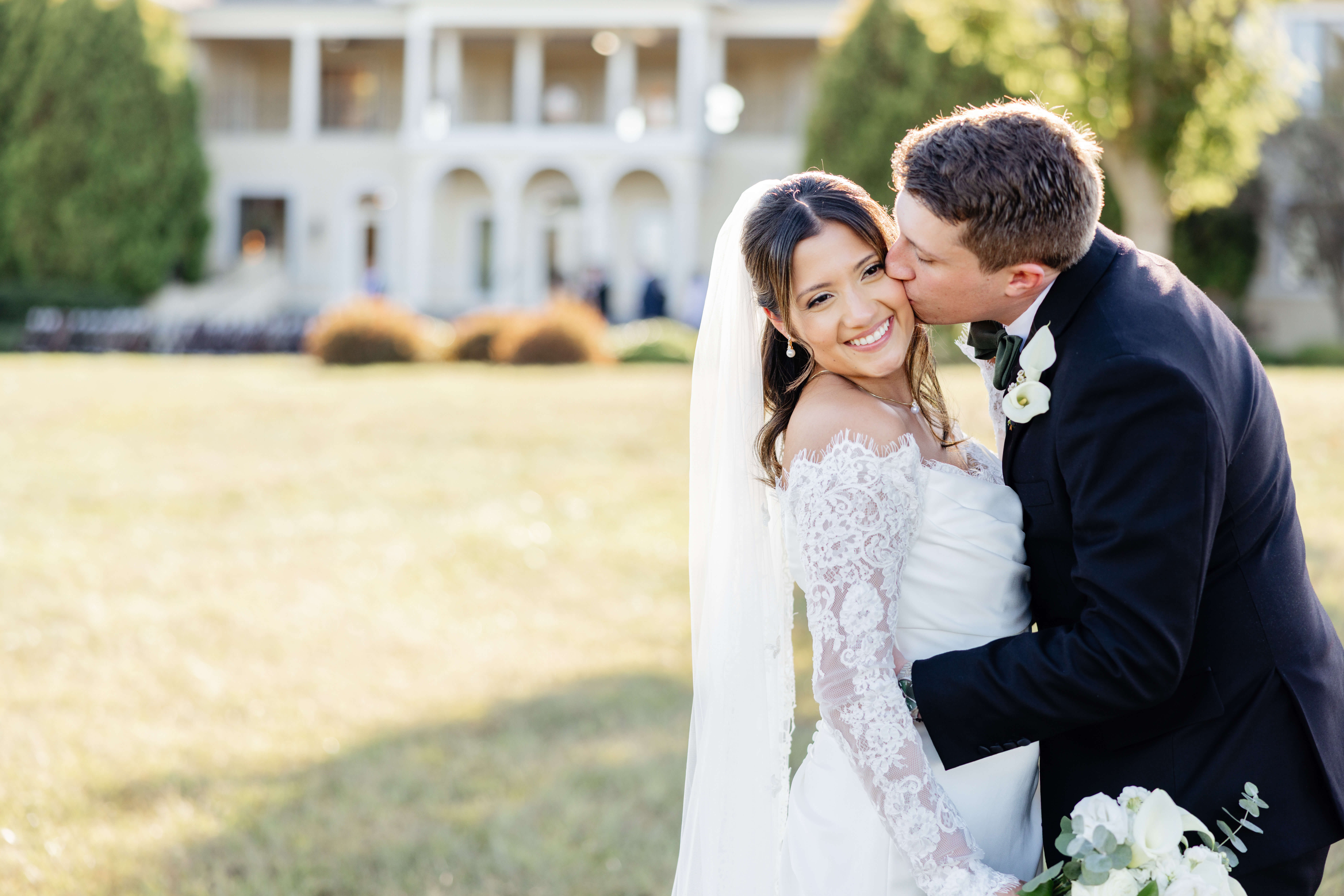 CrossKeys Vineyard Fall Wedding Photography 26 Groom kissing bride's cheek as she smiles in front of crosskeys vineyard