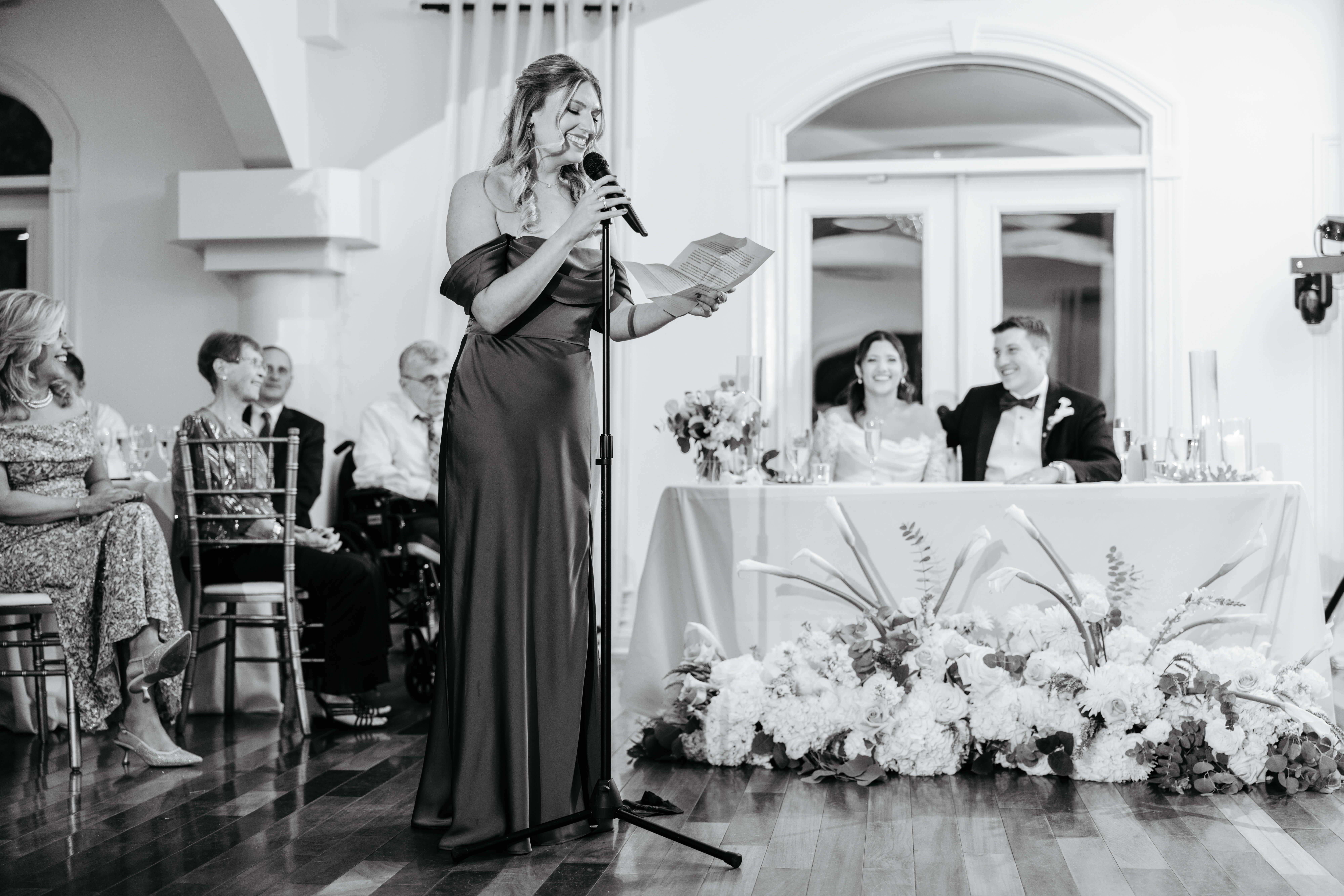 CrossKeys Vineyard Fall Wedding Photography 38 Bridesmaid giving speech as bride and groom as well as other guests smile in background