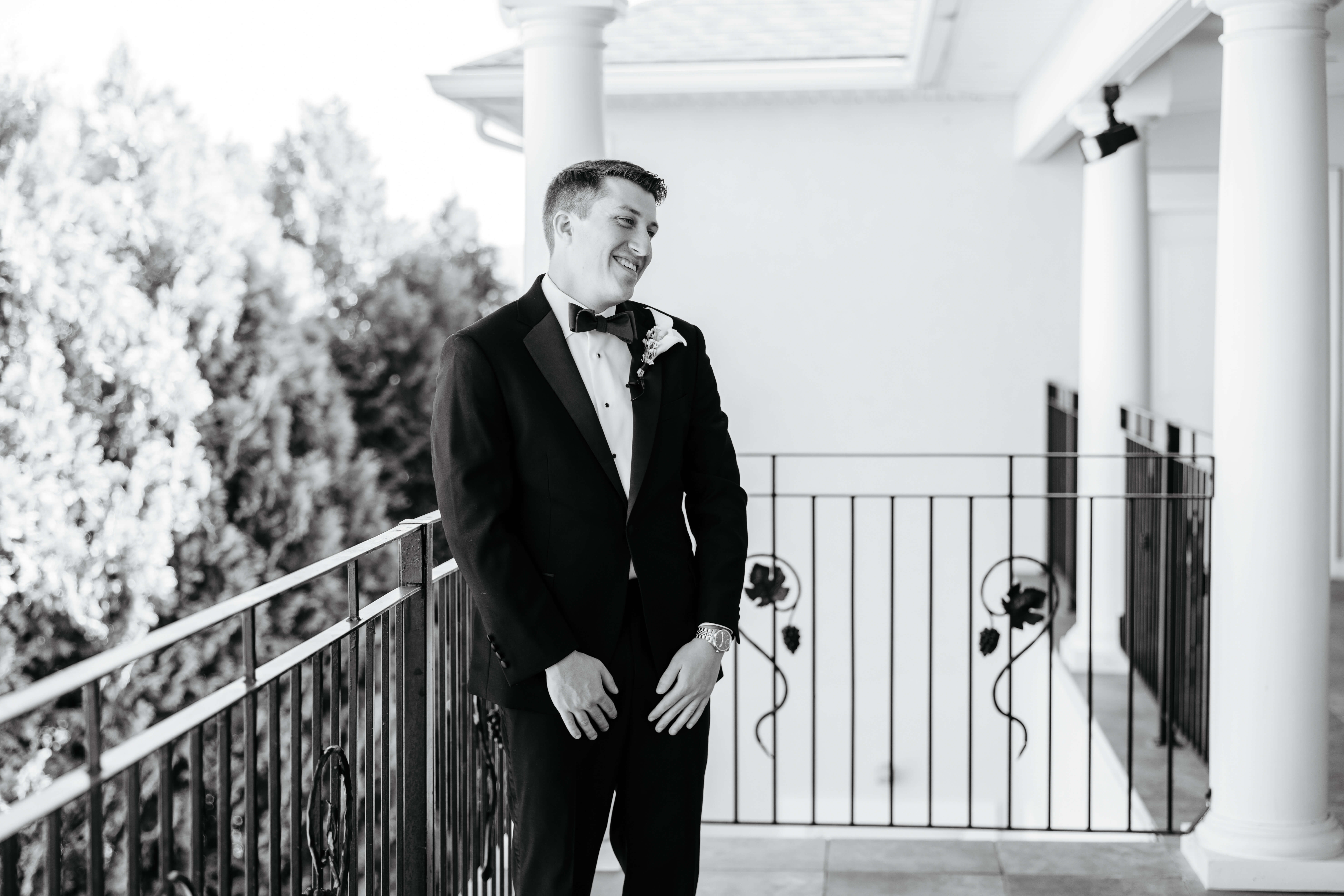 CrossKeys Vineyard Fall Wedding Photography 12 Black and white photo of groom turning around smiling as he sees bride in her dress for the first time