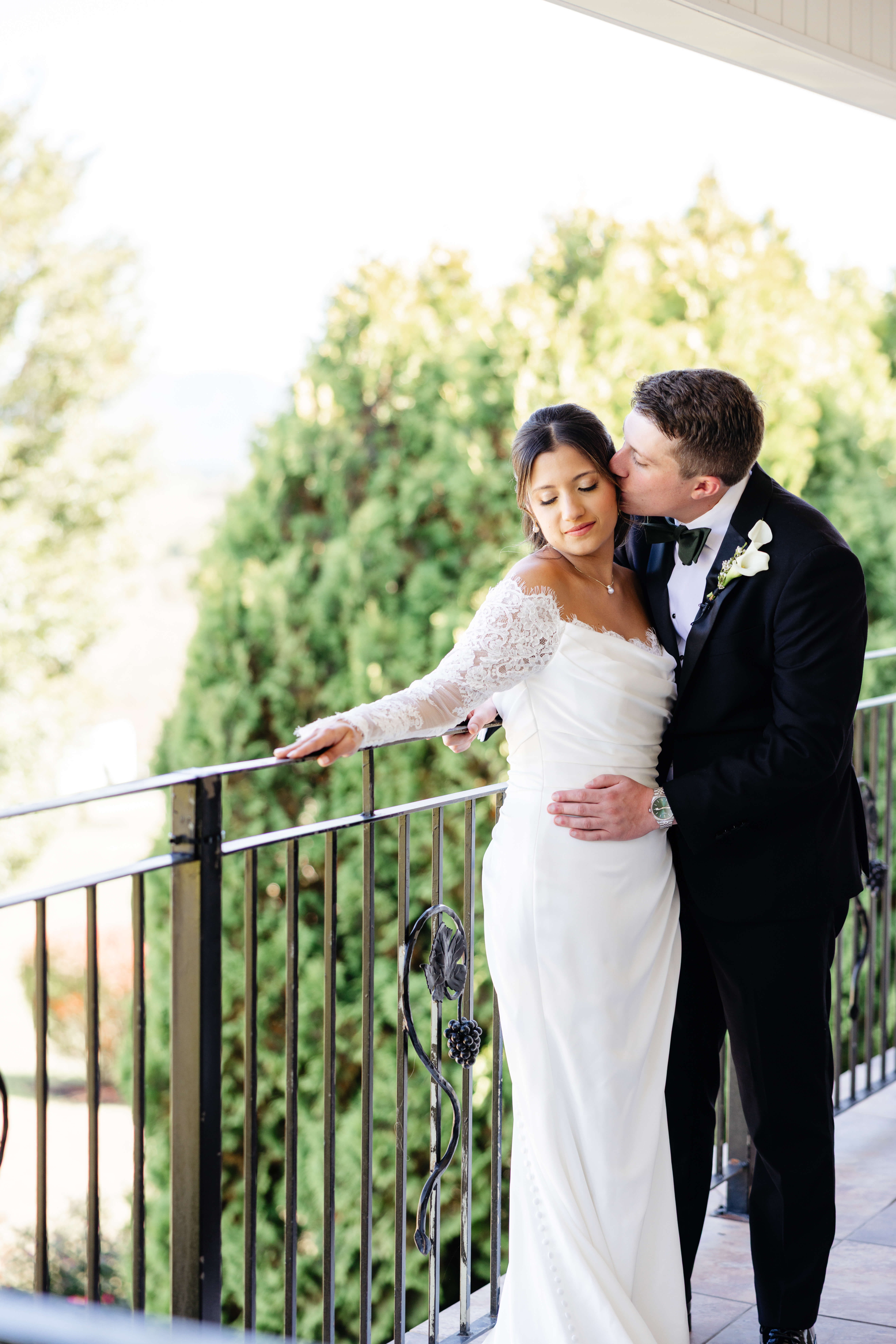 CrossKeys Vineyard Fall Wedding Photography 14 Groom kissing bride's head as she looks down with a subtle smile