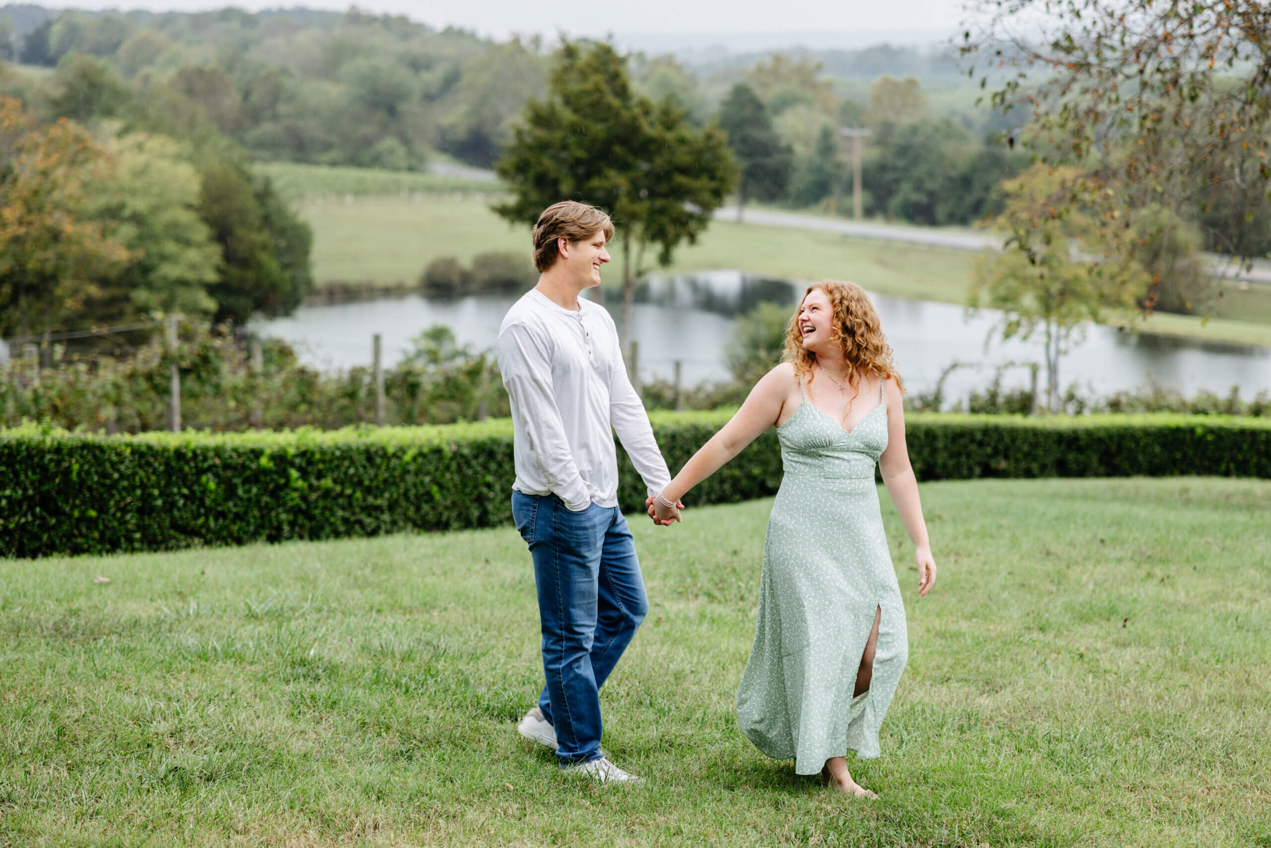Rassawek Vineyards Fall Engagement Photography 3 Engaged couple walking hand in hand through the grass at rassawek vineyards