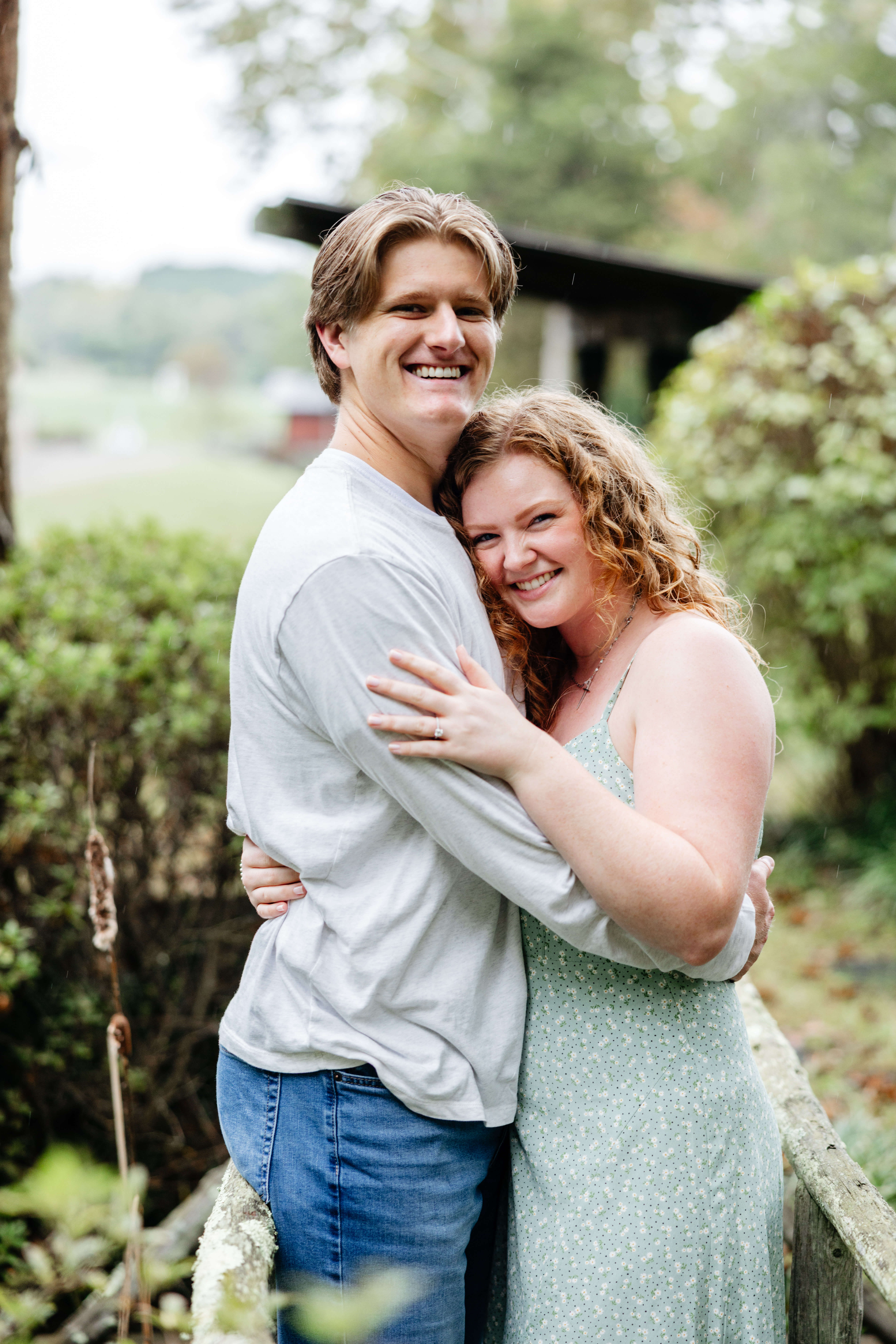 Rassawek Vineyards Fall Engagement Photography 9 Engaged couple hugging as they both turn to smile at camera
