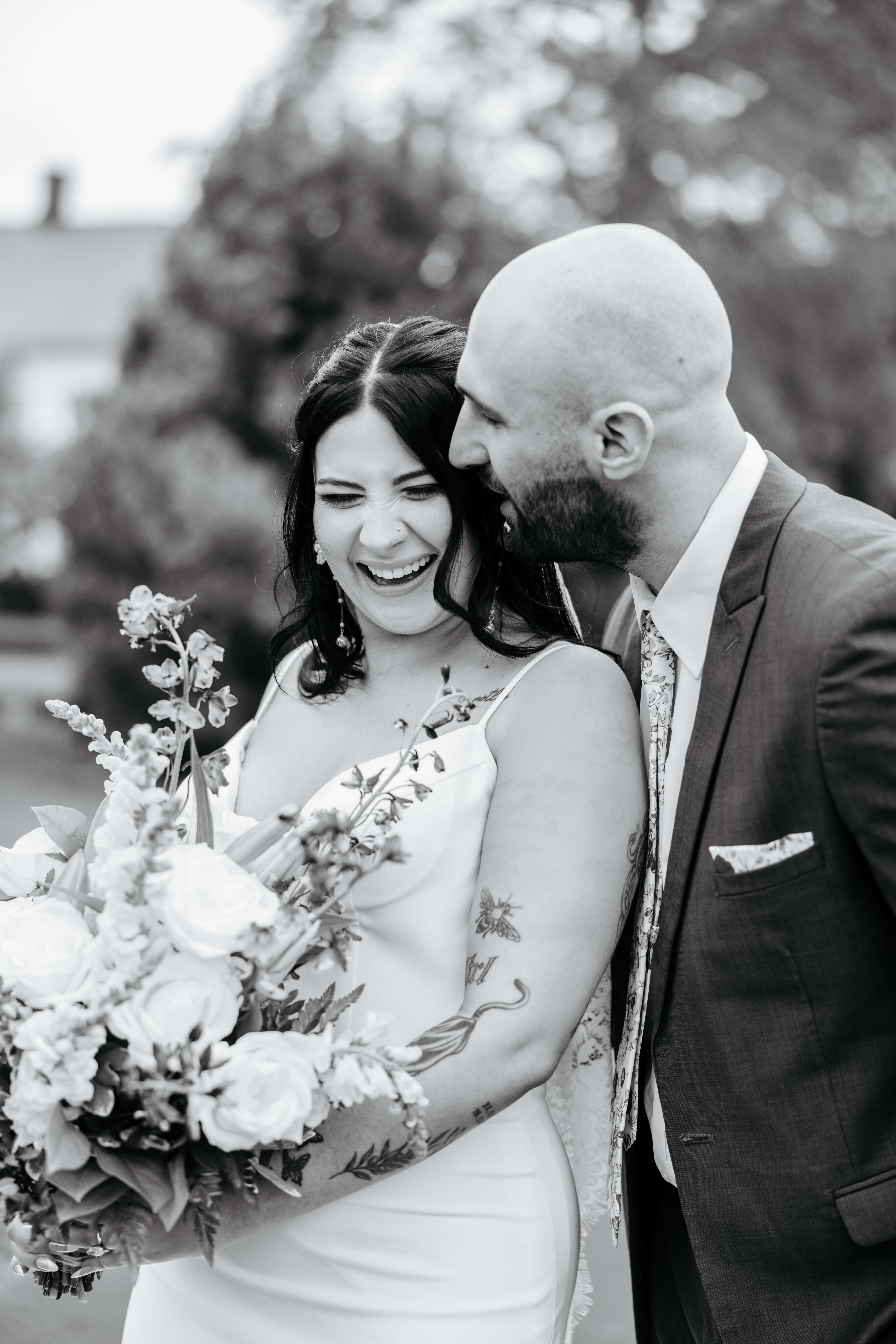 Barns of Kanak October Wedding 21 Black and white photo of groom whispering something as bride laughs, closing her eyes