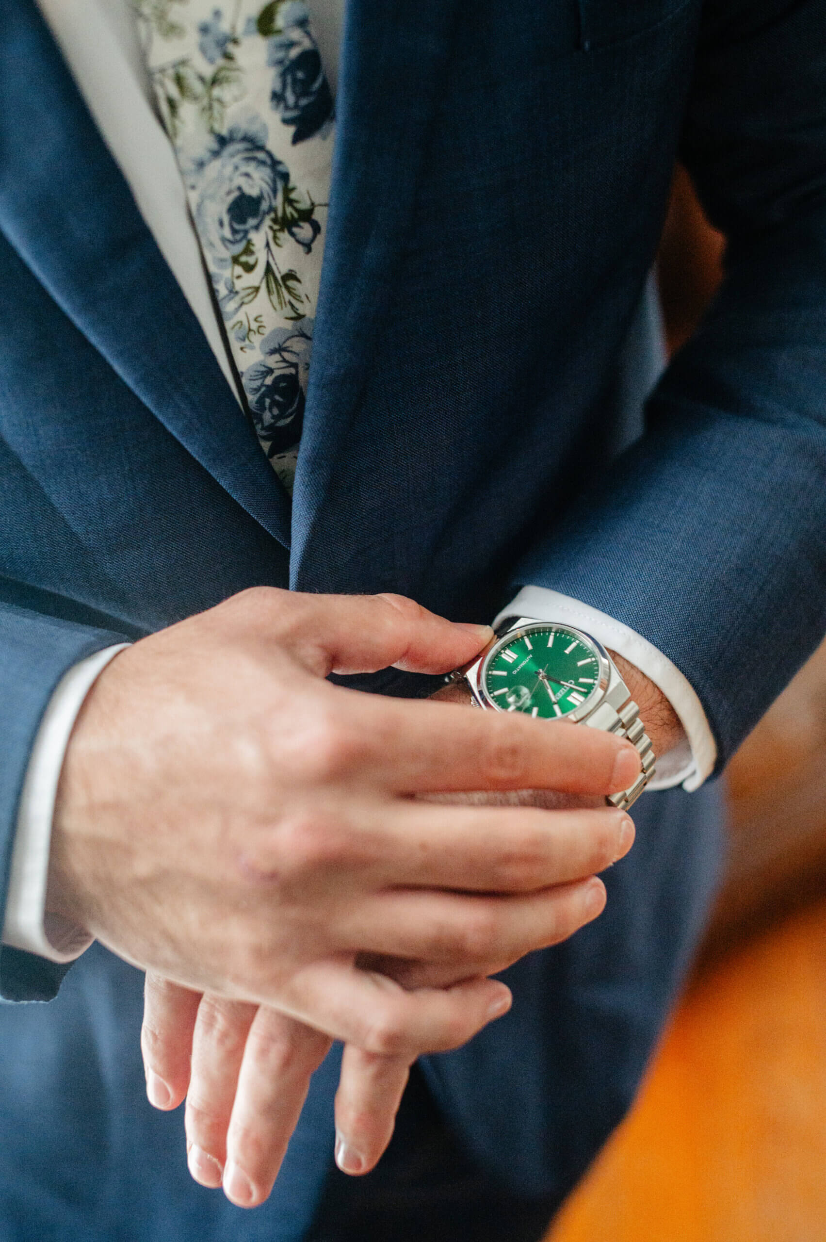 Barns of Kanak October Wedding 6 Groom's hands as he looks at the time on his silver watch with a green watch face
