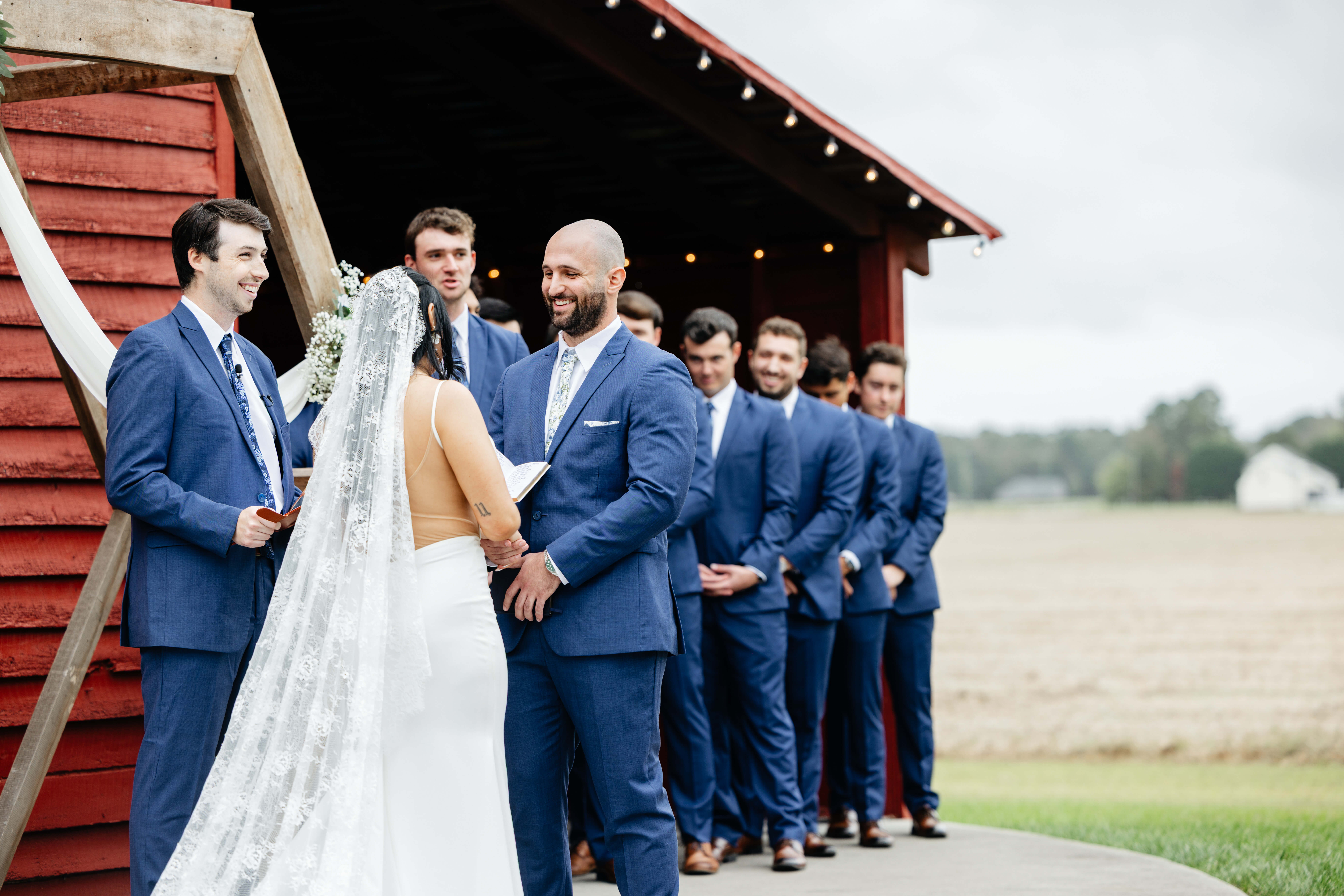 Barns of Kanak October Wedding 28 Groom smiling at bride, officiant and groomsmen all smiling as well