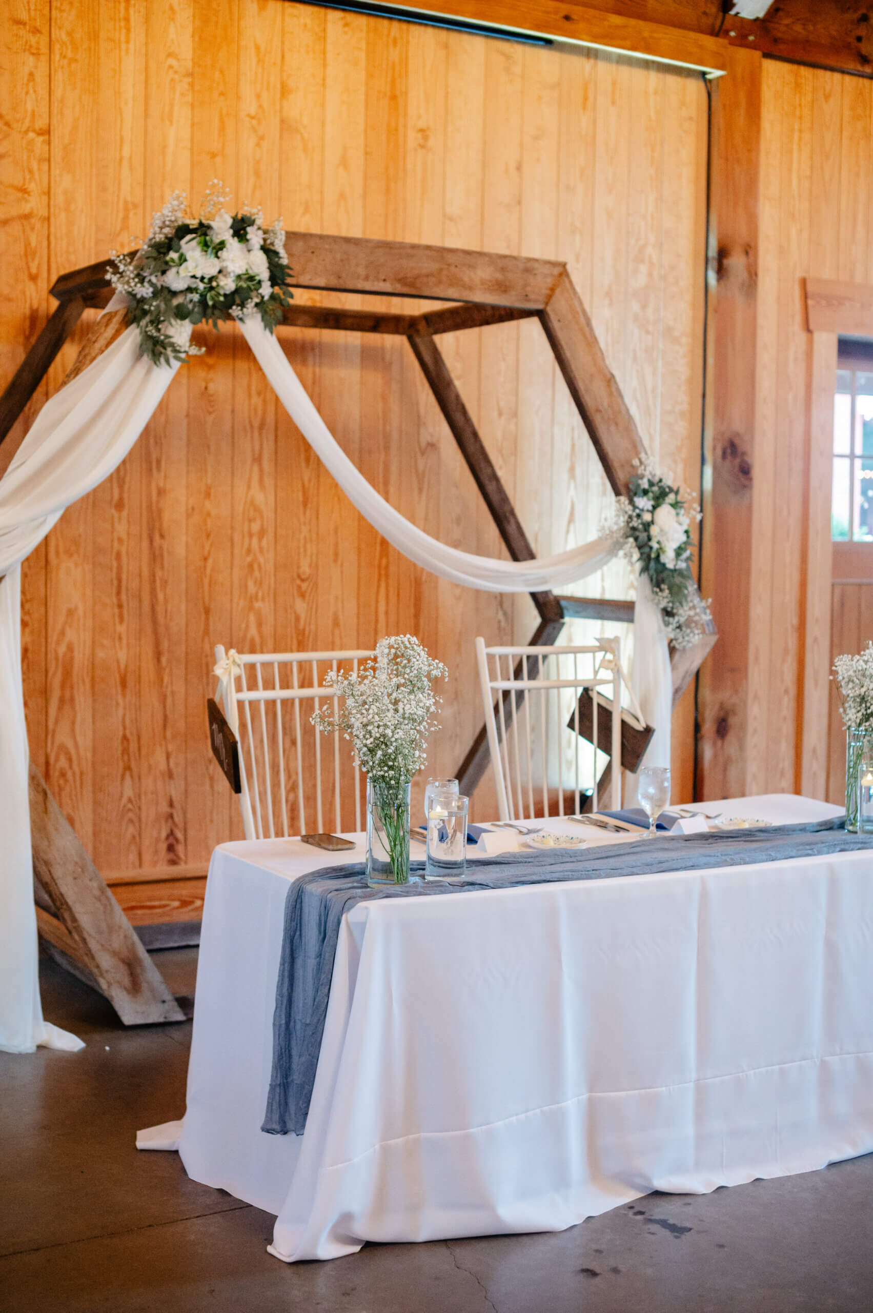 Barns of Kanak October Wedding 33 Sweetheart table with dusty blue table runner and two white chairs