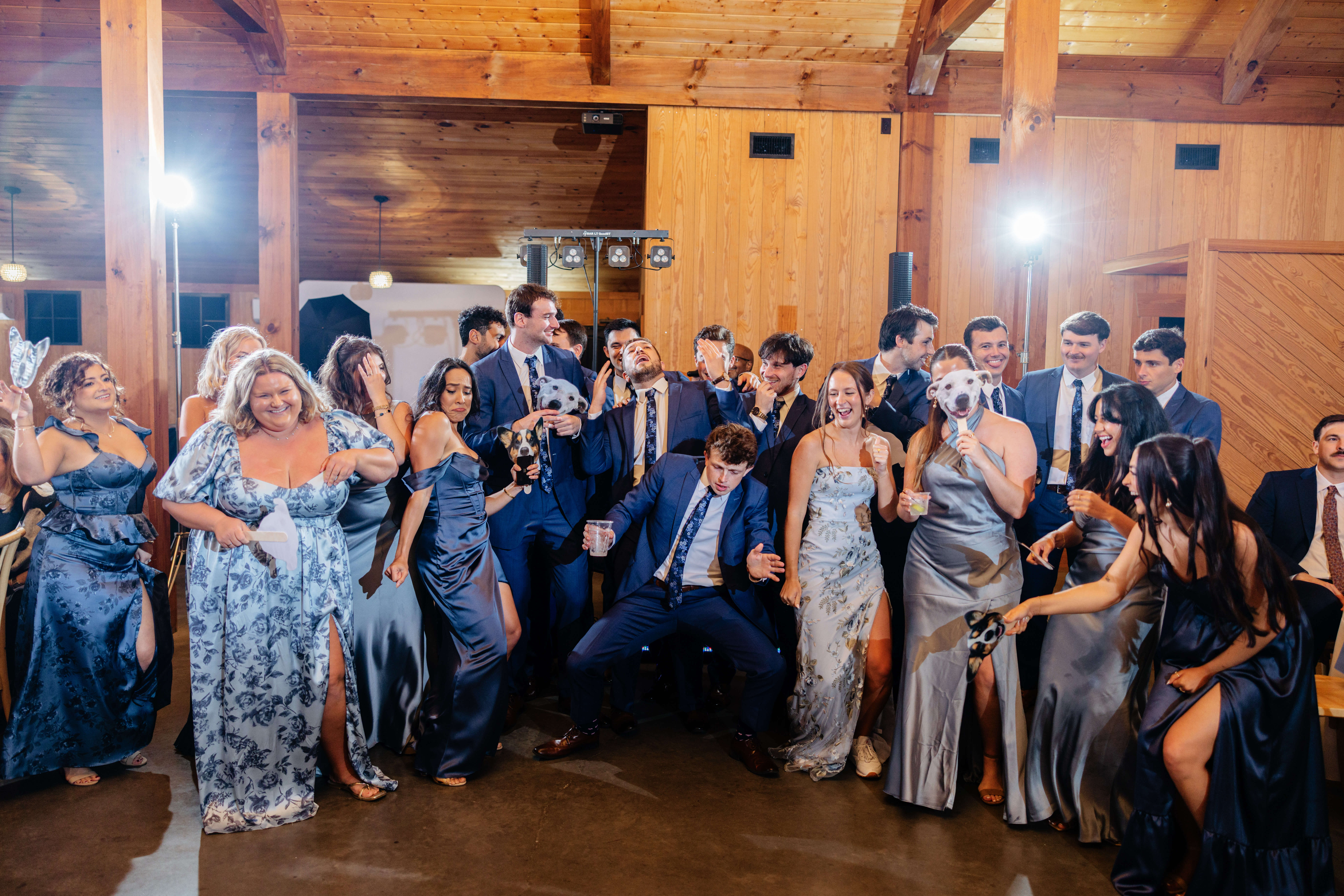 Barns of Kanak October Wedding 36 Bridesmaids and groomsmen pose hilariously laughing and smiling, dancing and holding up picture cut outs of the couple's dogs faces