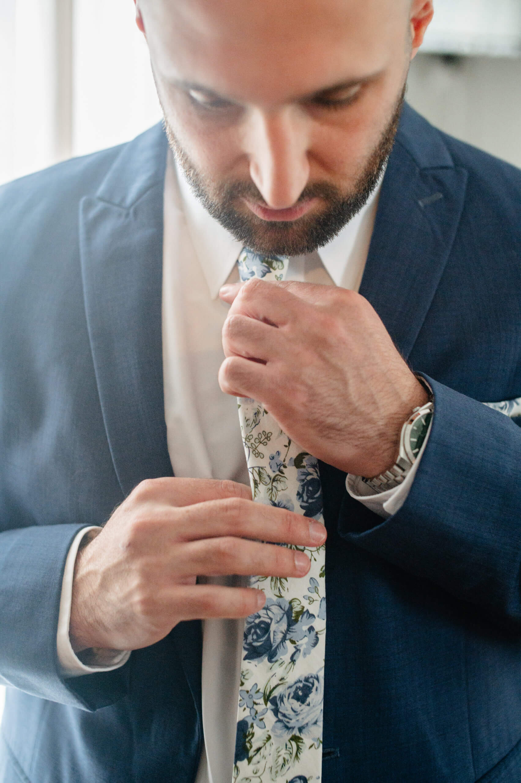 Barns of Kanak October Wedding 5 Groom adjusting his white tie with blur flowers on it