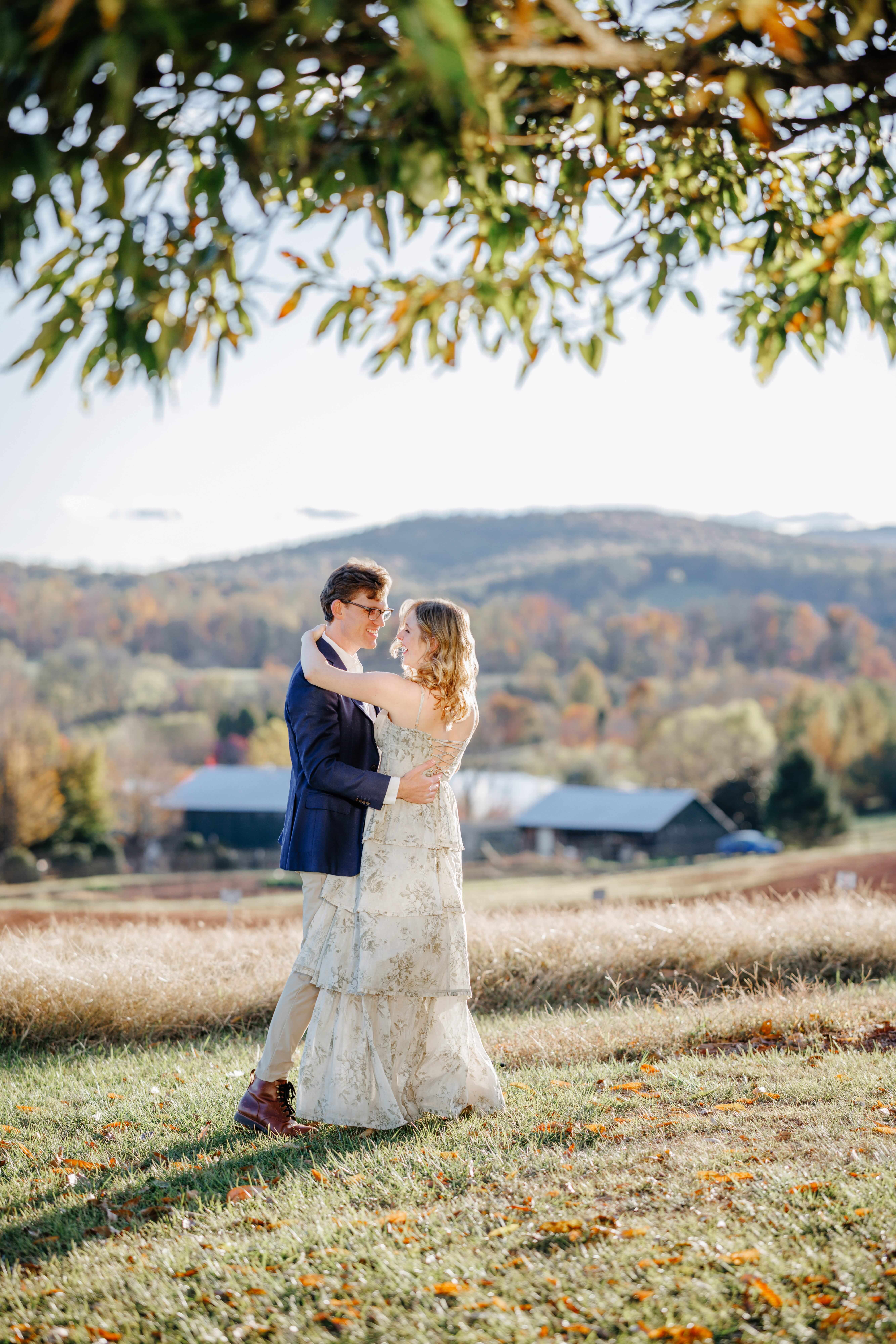 Market at Grelen Fall Engagement Photography 4 Engaged couple dancing at market at grelen, barn and hills in background with fall colors in the trees