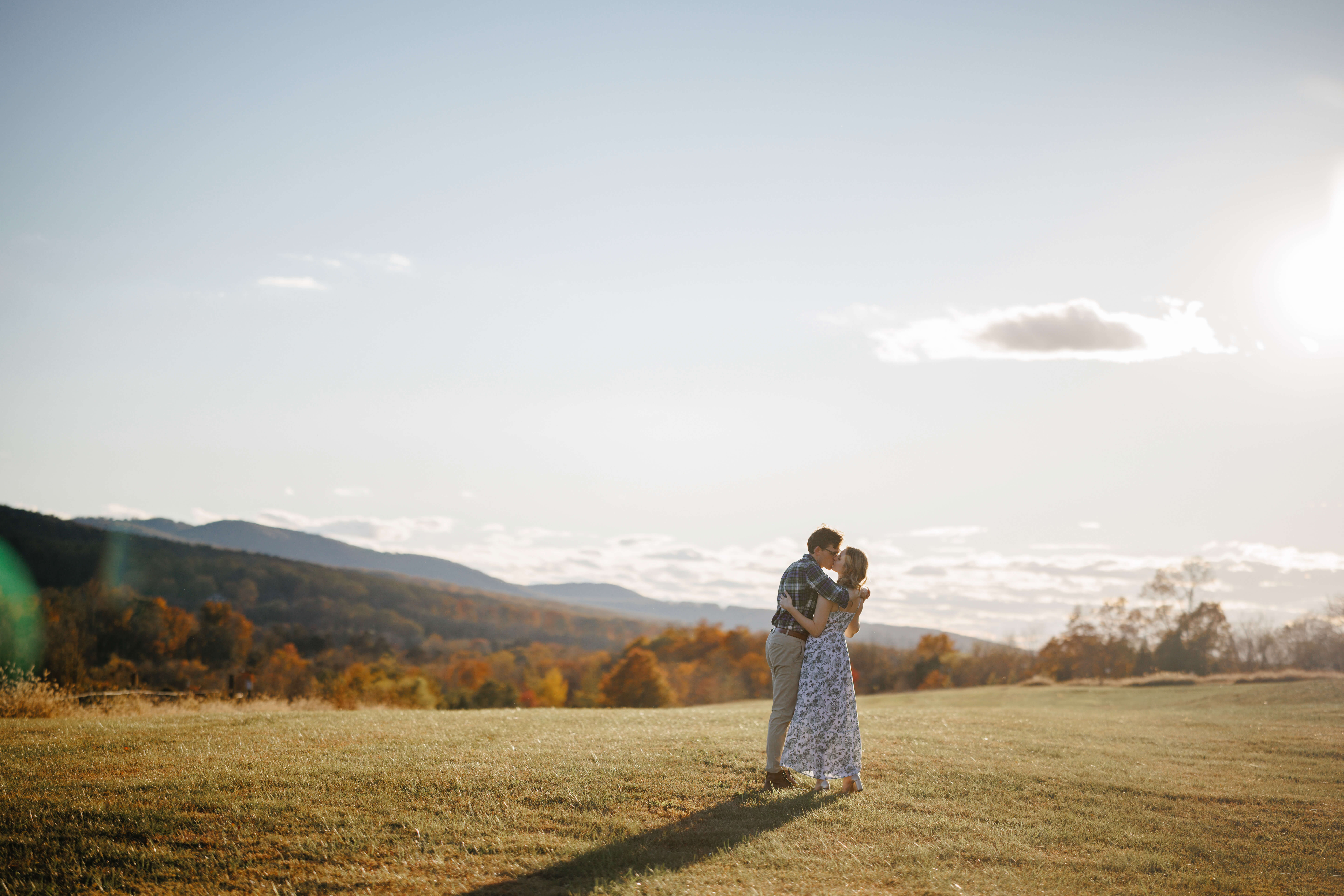 Market at Grelen Fall Engagement Photography 7 Wide landscape shot as the sun starts to set, engaged couple share a kiss