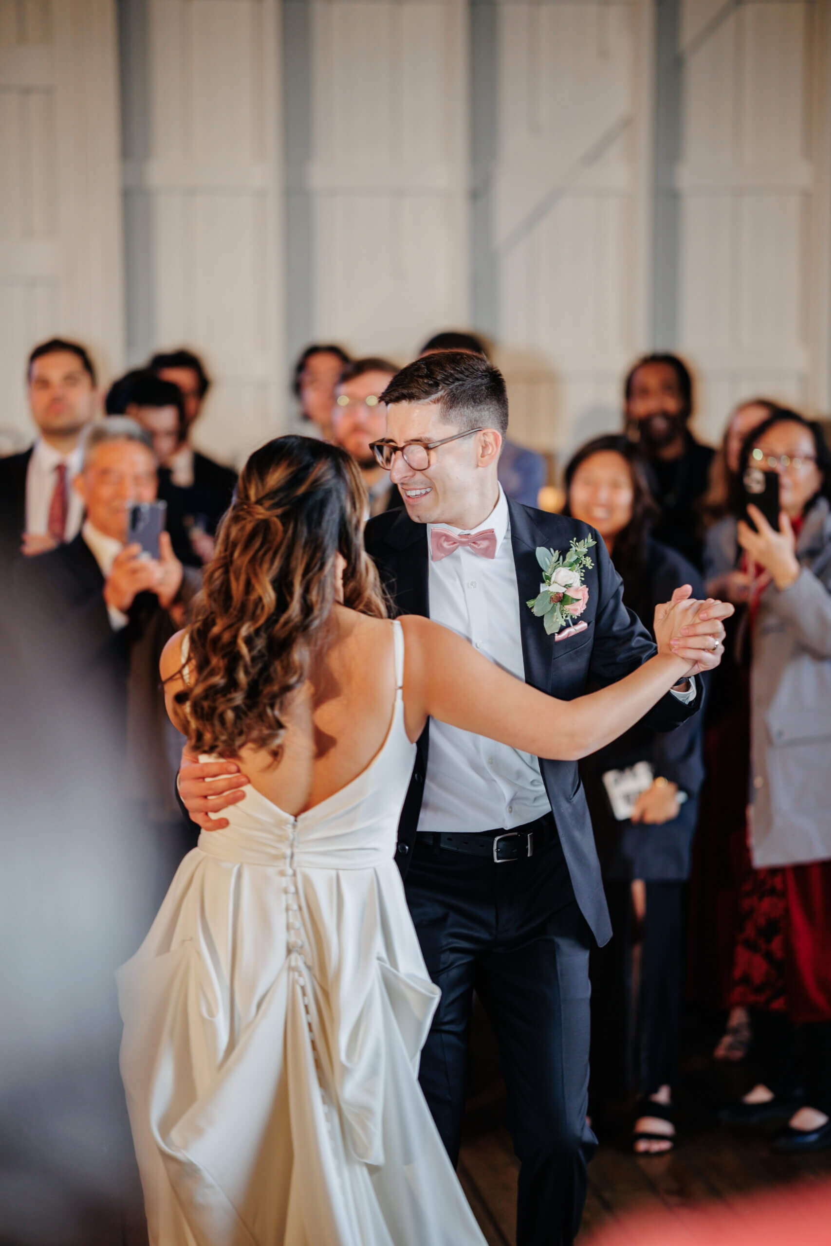 Valley Road Vineyard Fall Wedding 43 Bride and groom dancing for their first dance as guests watch and take photos in background