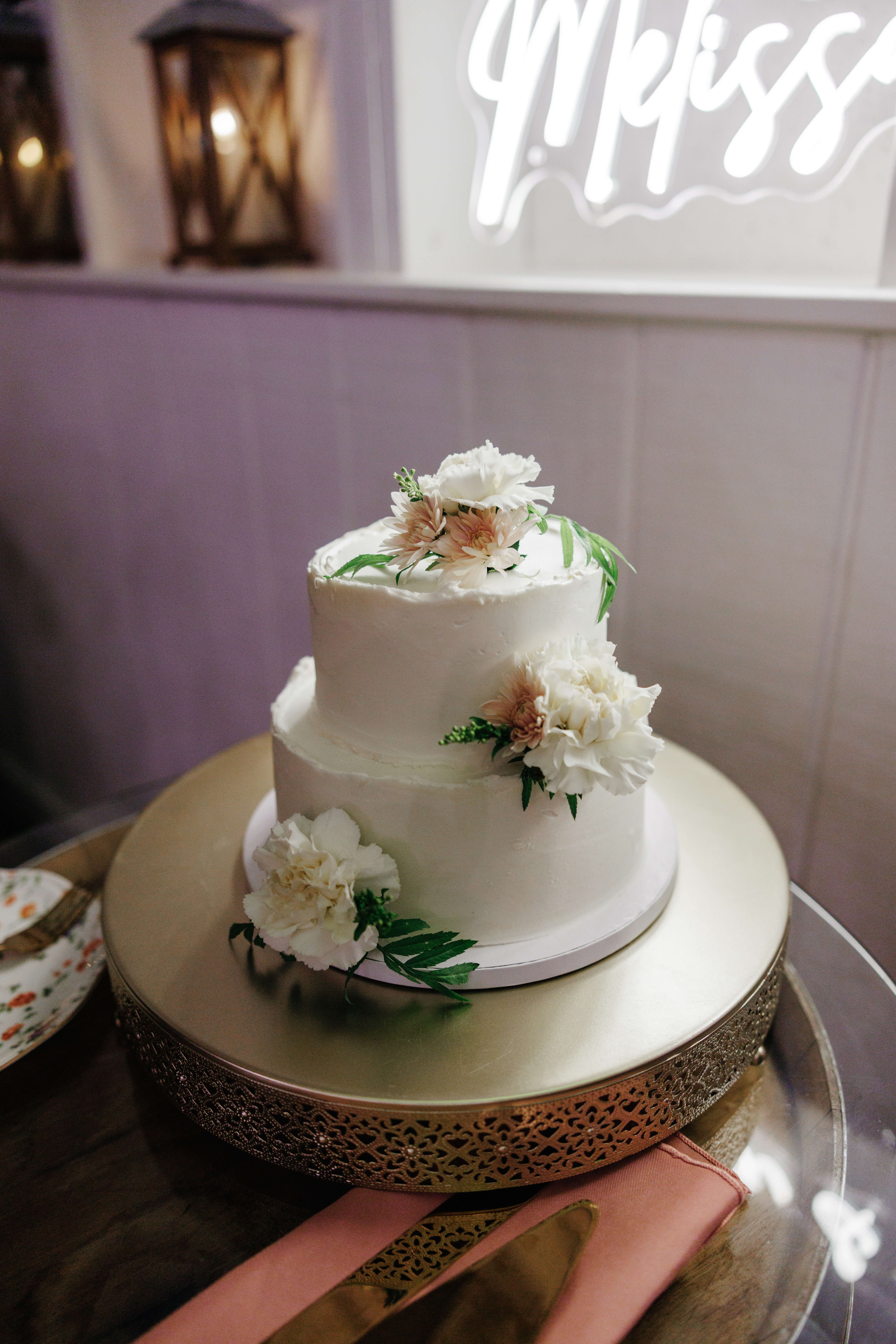 Valley Road Vineyard Fall Wedding 48 Two tiered white wedding cake with white real white floral accents on each level