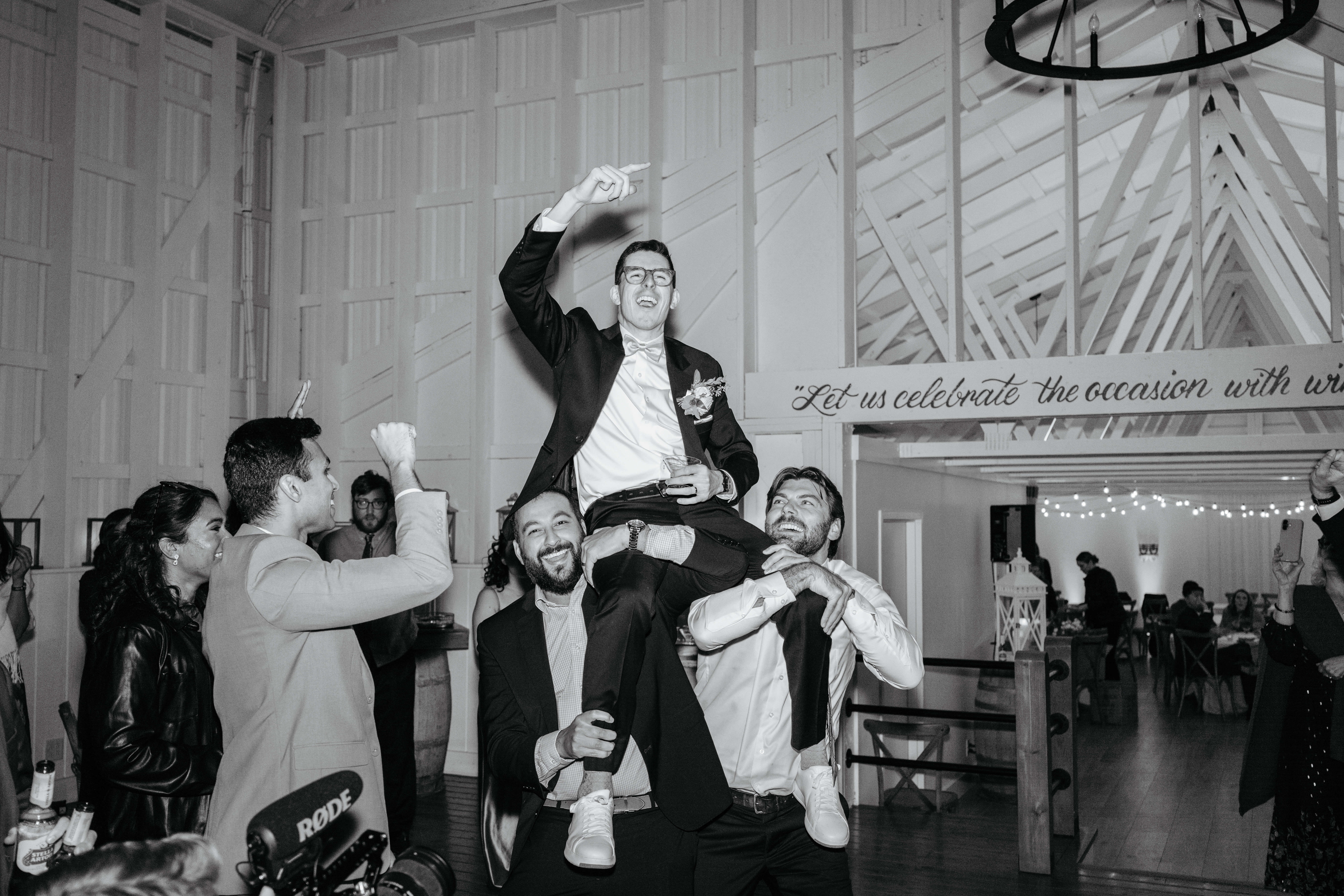 Valley Road Vineyard Fall Wedding 51 Black and white photo of groom being lifted up onto shoulders at the wedding reception