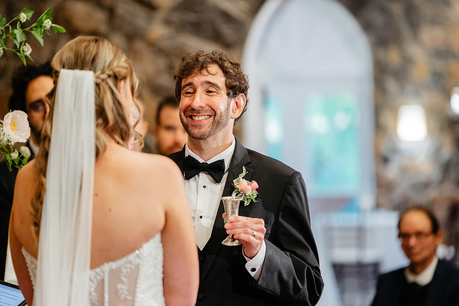 Poplar Springs Manor Spring Wedding Photography 23 groom smiling at bride and he does religious ceremonial acts