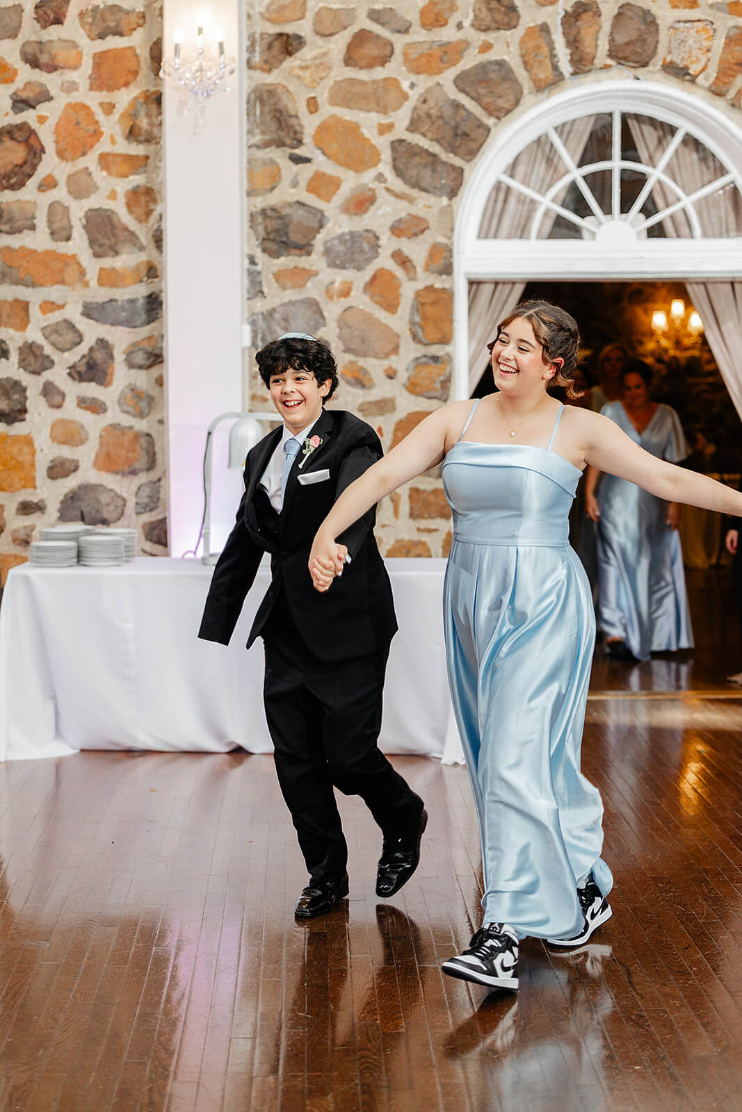 Poplar Springs Manor Spring Wedding Photography 32 couple from wedding party entering the reception