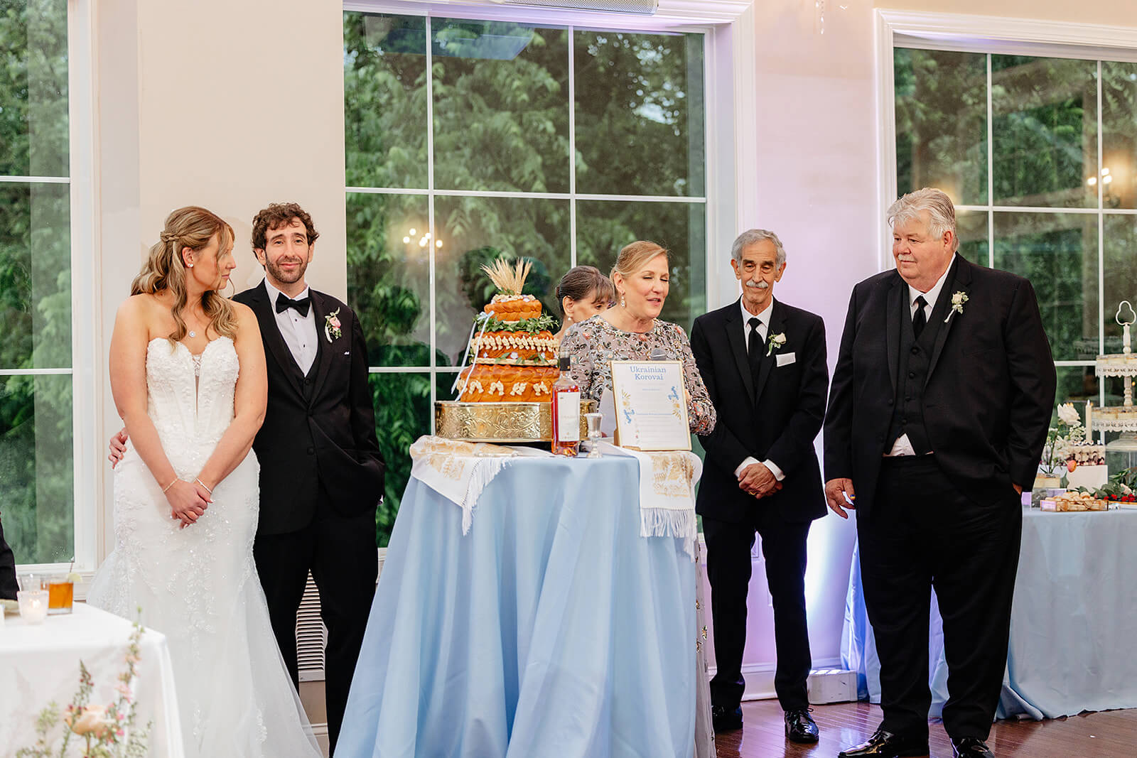 Poplar Springs Manor Spring Wedding Photography 33 bride and groom standing by ukranian cake with parents