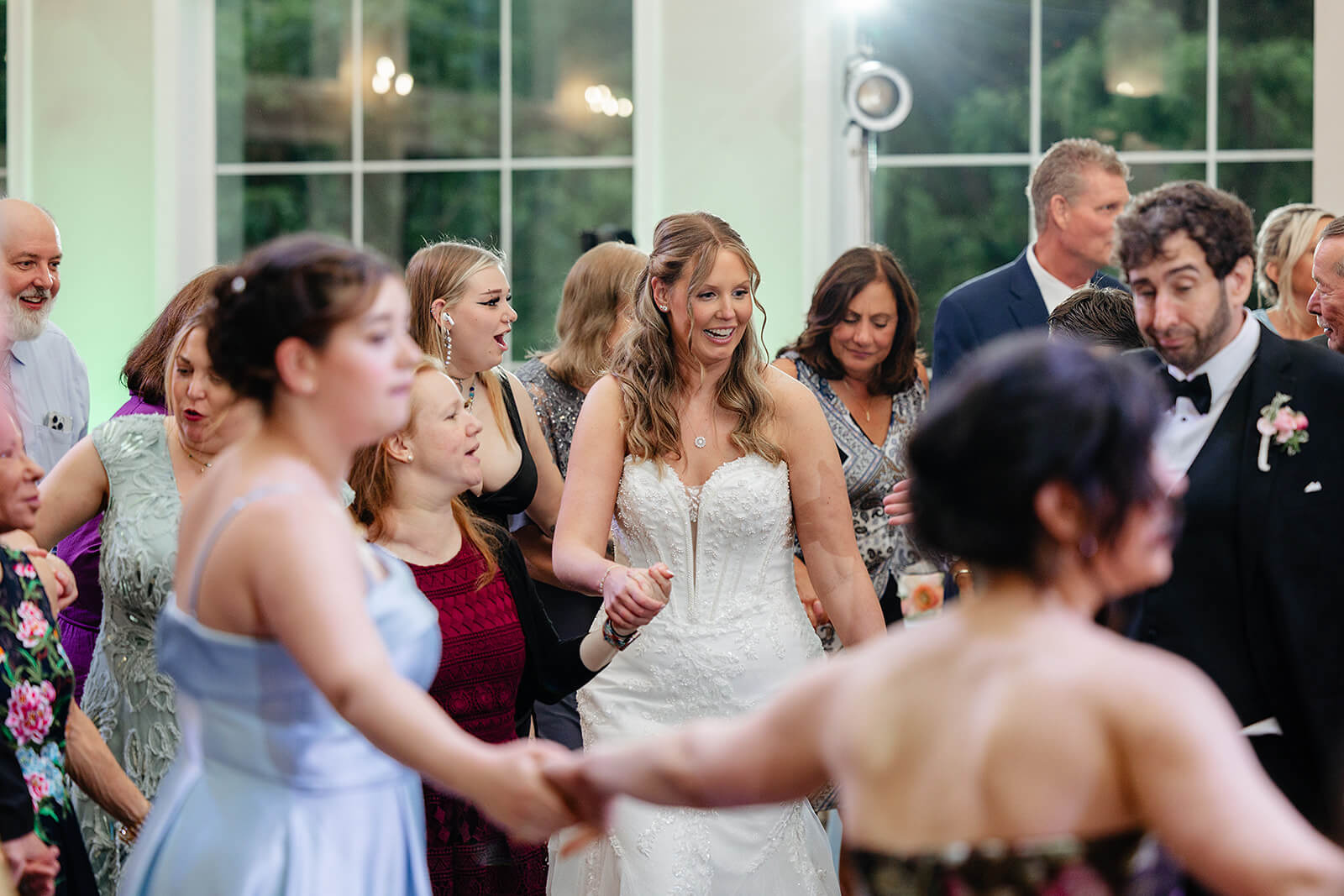 Poplar Springs Manor Spring Wedding Photography 35 guests holding hands with guests and standing in a circle