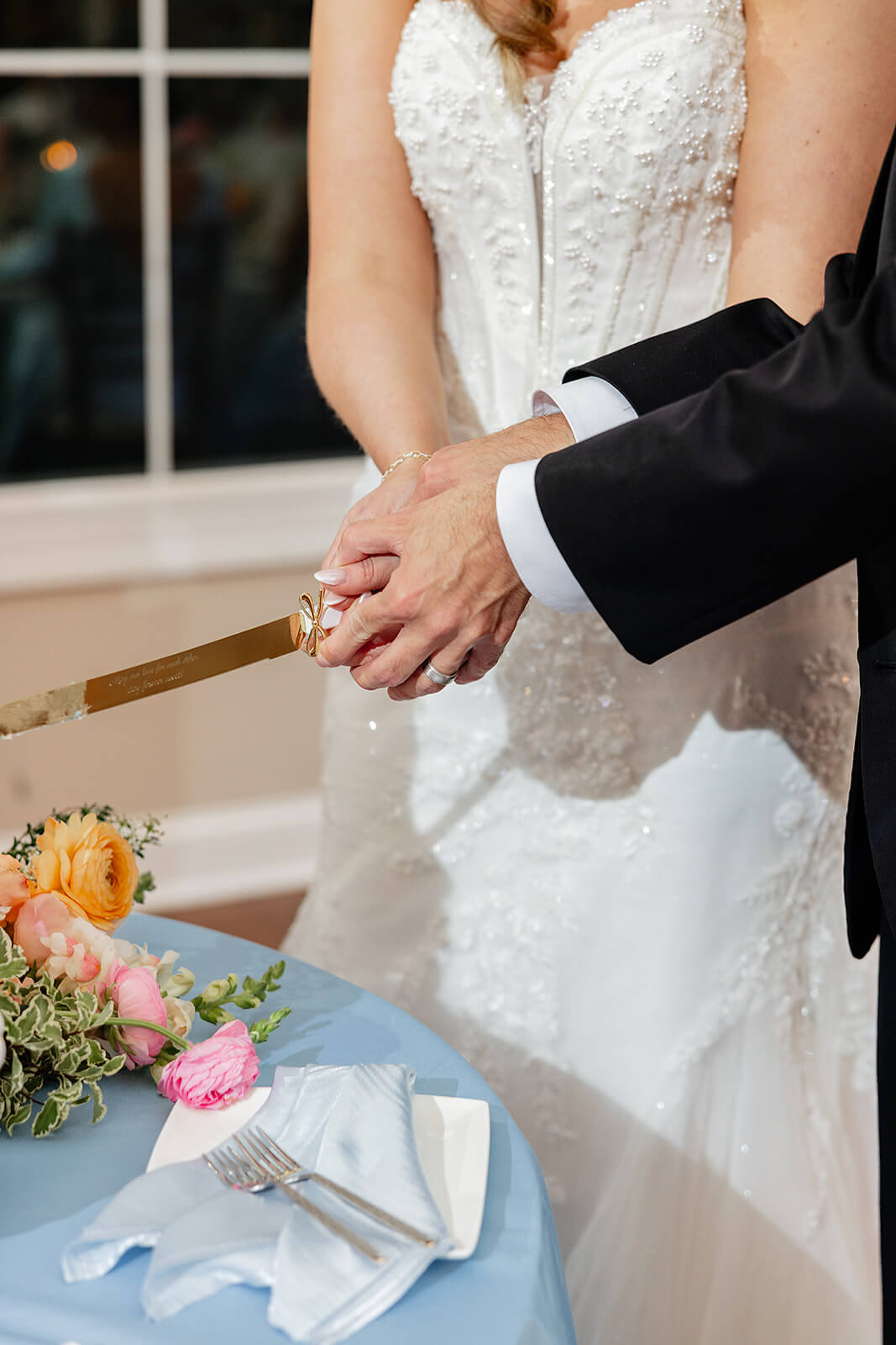 Poplar Springs Manor Spring Wedding Photography 42 bride and groom holding a large knife to cut their wedding cake