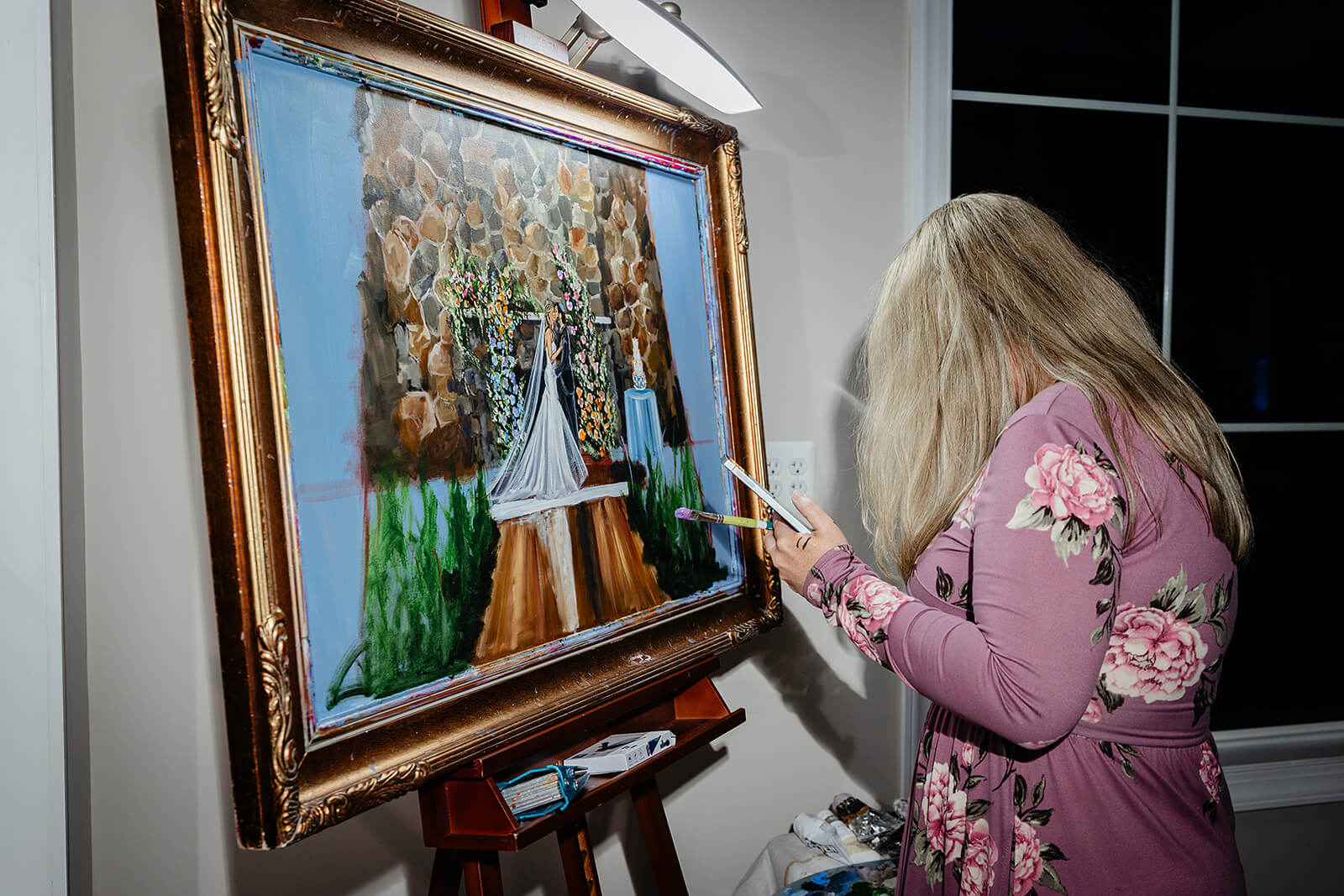 Poplar Springs Manor Spring Wedding Photography 45 artist finishing live painting of bride and groom's ceremony