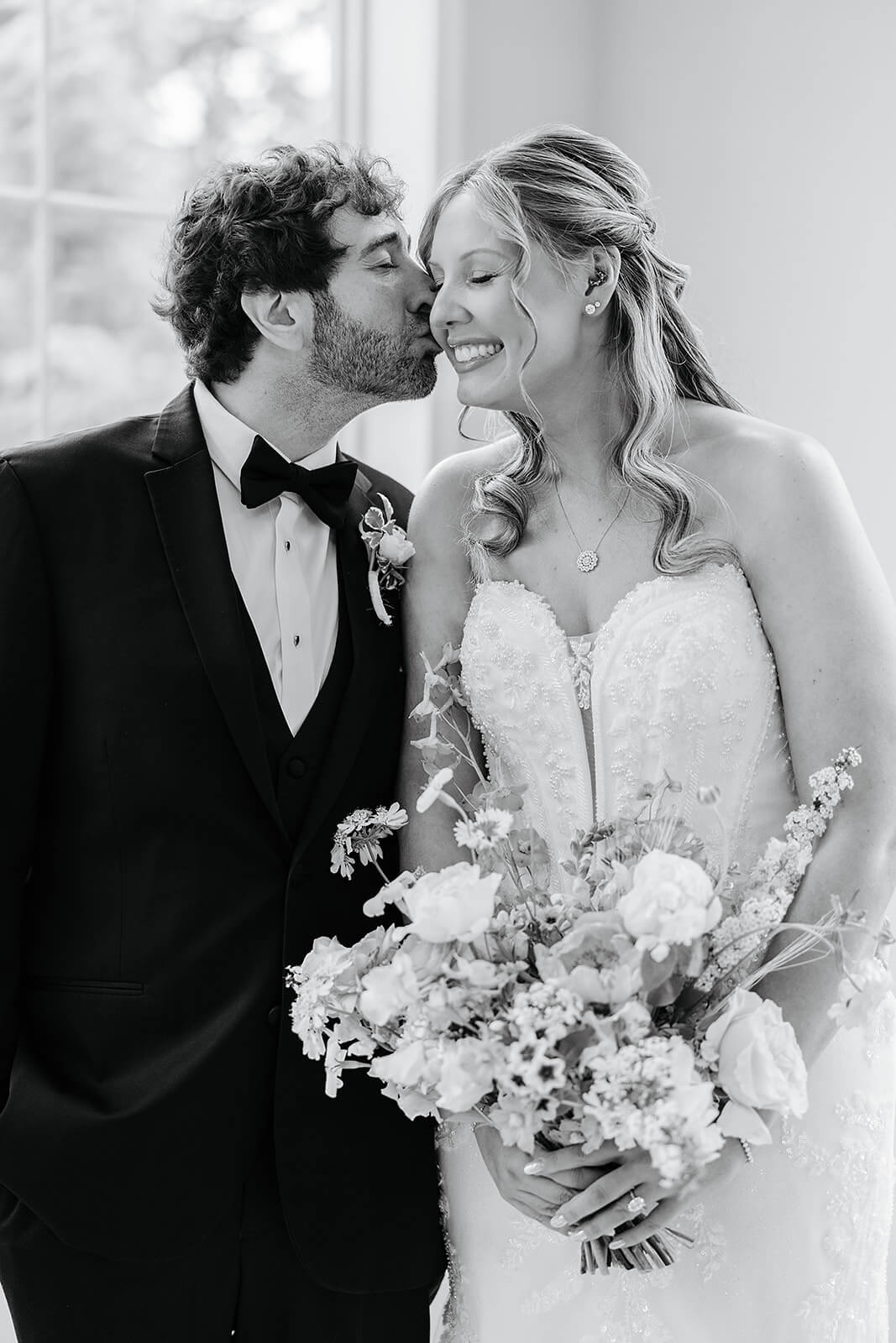 Poplar Springs Manor Spring Wedding Photography 10 black and white photo of groom kissing bride on the cheek
