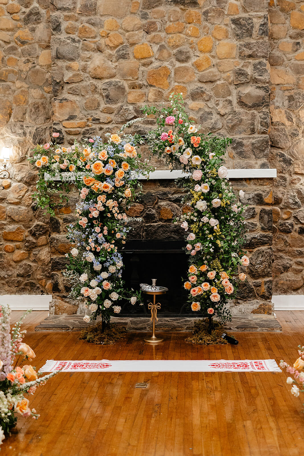 Poplar Springs Manor Spring Wedding Photography 16 alter with small gold stand and blue, orange, and pink floral arch