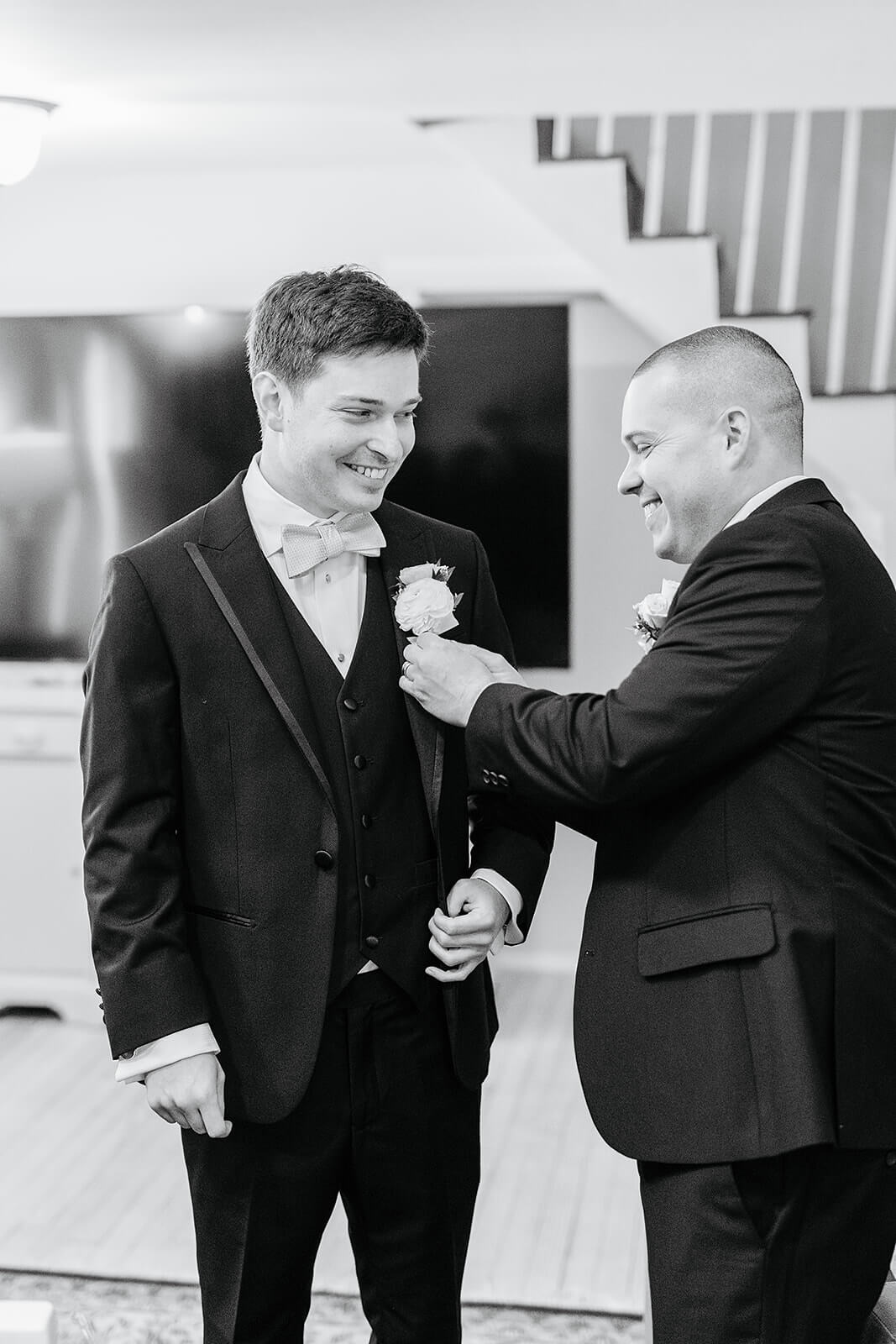 The Mill at Fine Creek Spring Wedding Photography in Powhatan 7 black and white photo of groom getting his flower put on